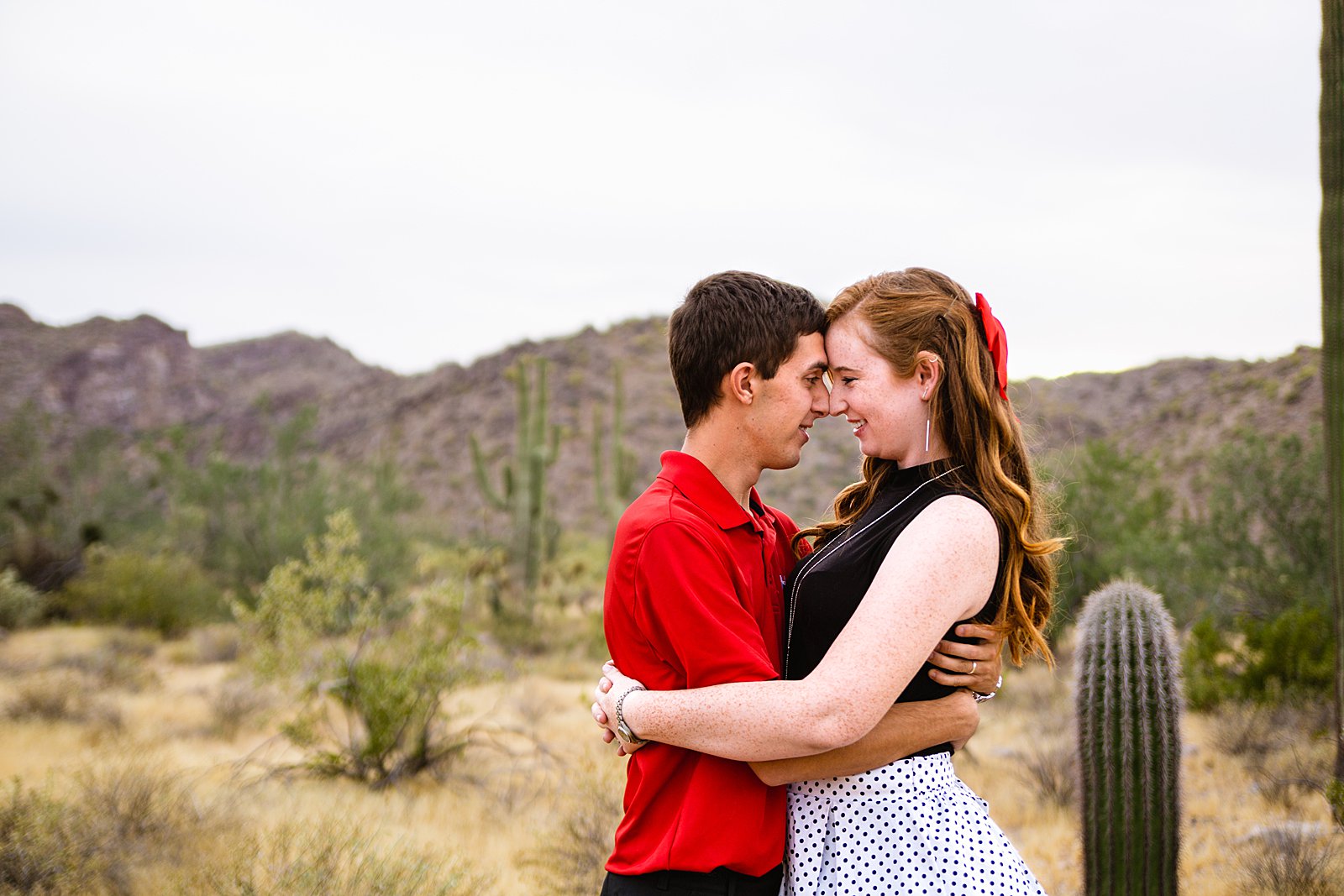Couple share an intimate moment at their Phoenix anniversary session by Arizona engagement photographer PMA Photography.