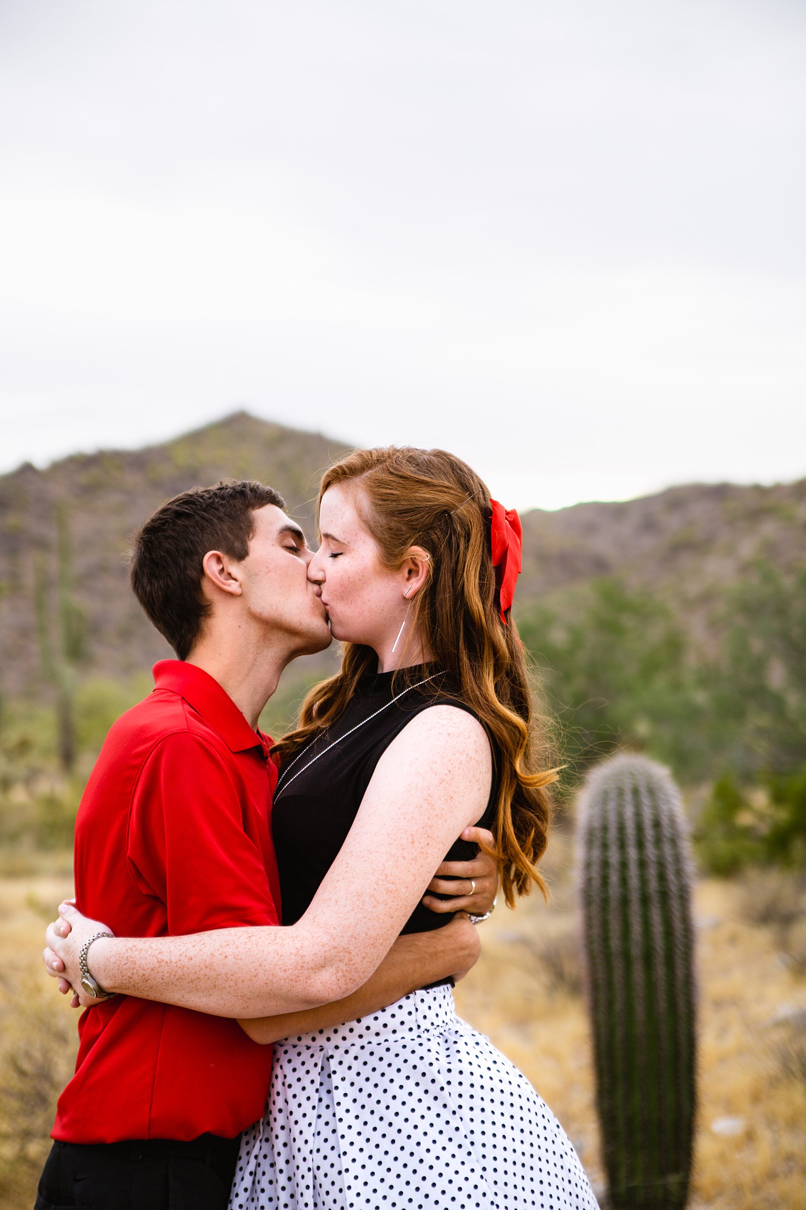 Couple share a kiss during their Phoenix anniversary session by Arizona wedding photographer PMA Photography.