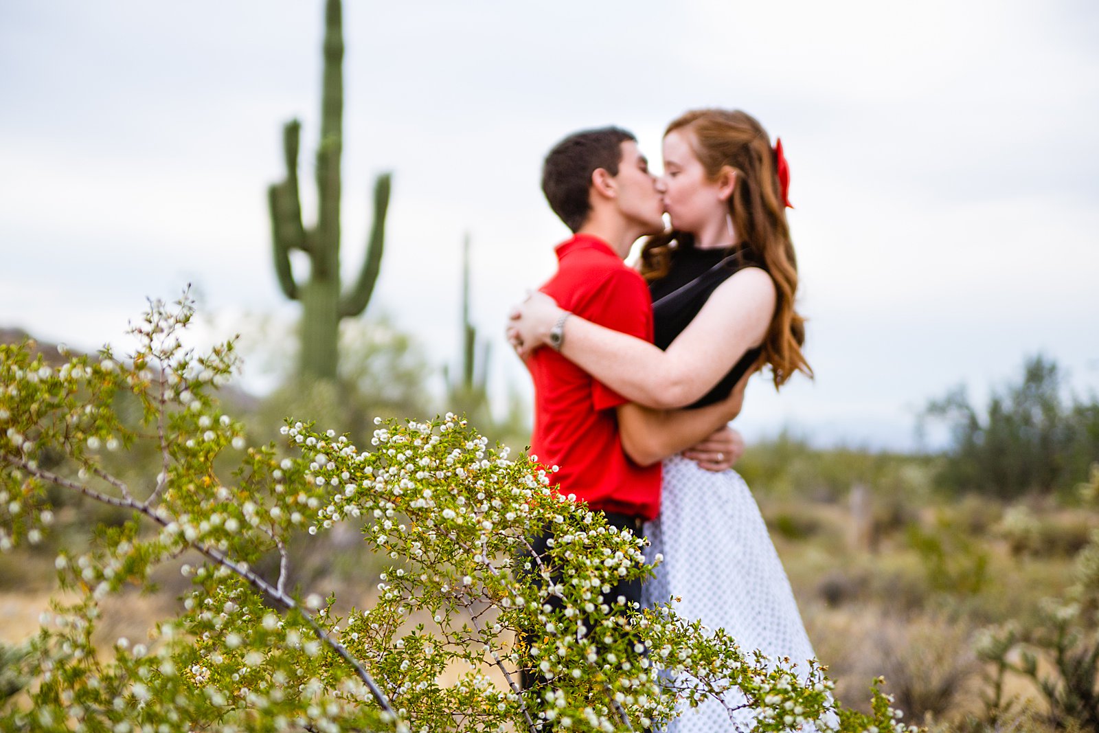 Couple share a kiss during their White Tanks anniversary session by Phoenix wedding photographer PMA Photography.