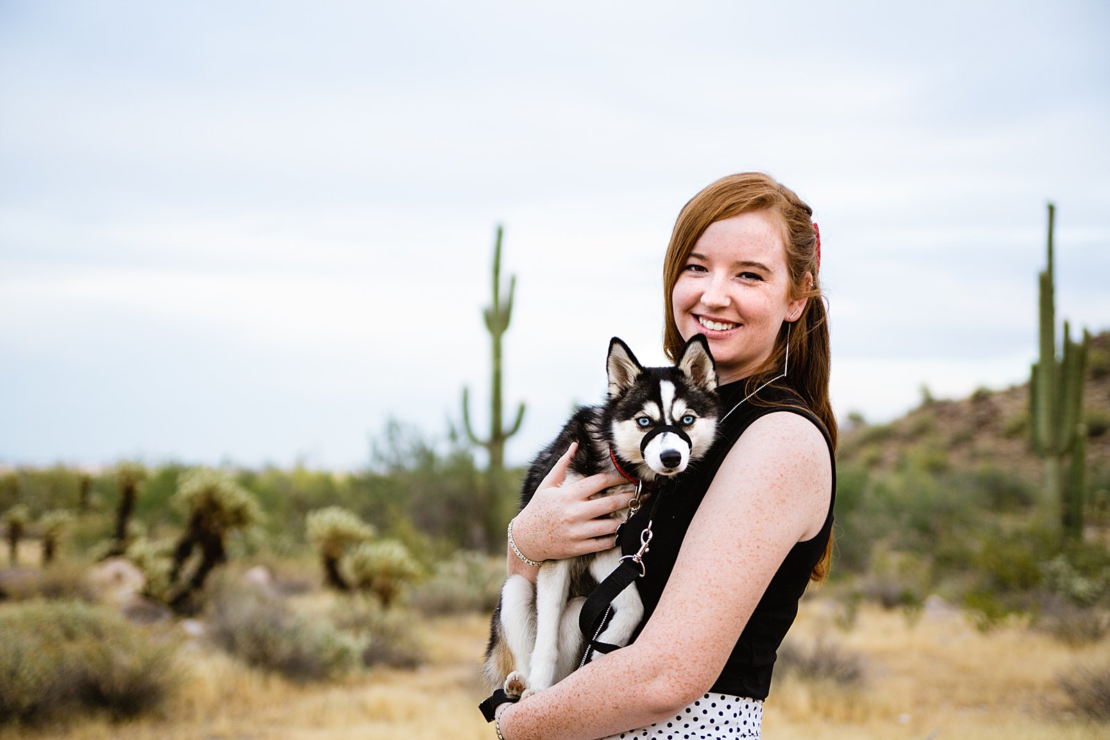 Lady poses with her dog during her anniversary session in the White Tanks by PMA Photography.