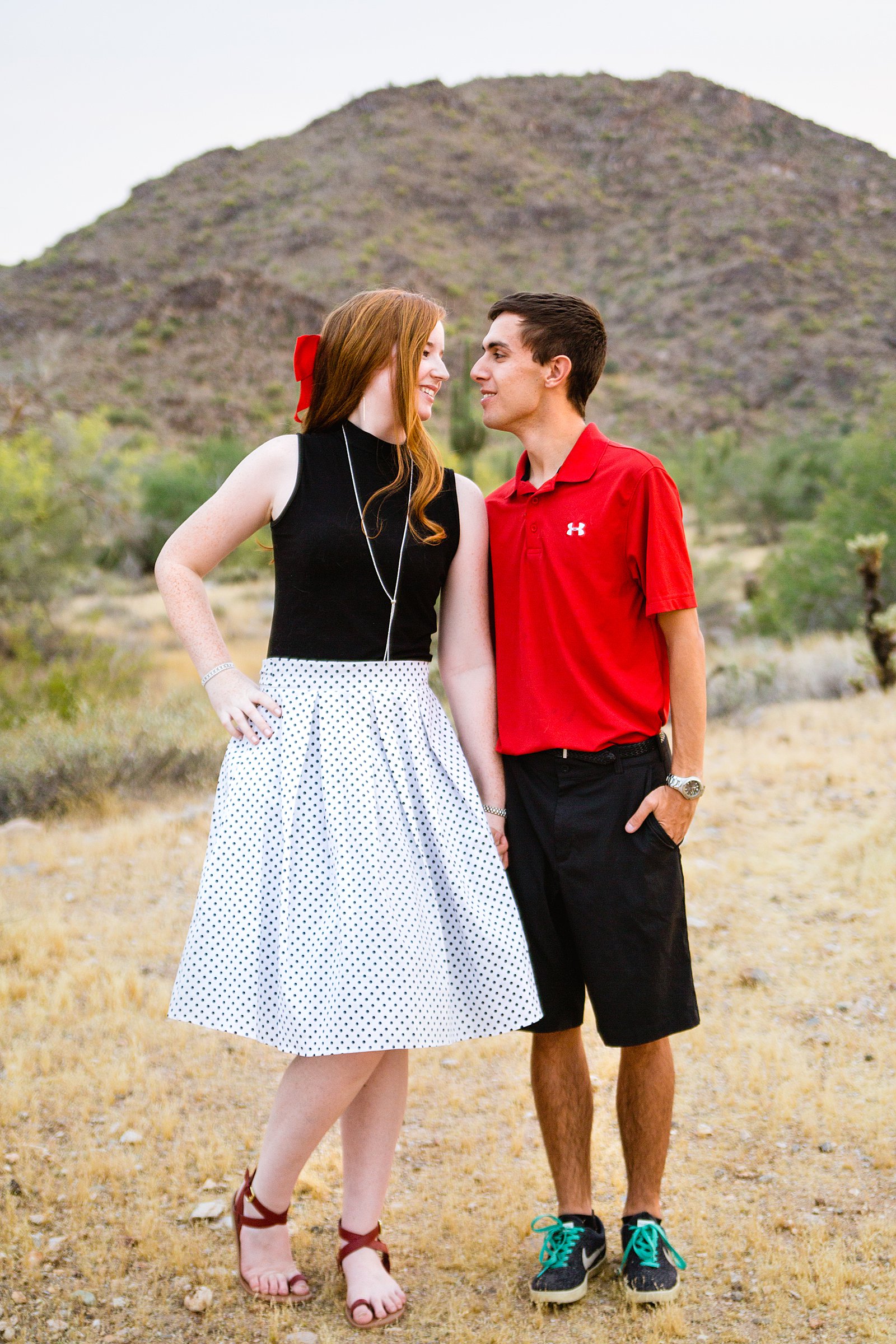 Couple look at each other during their Phoenix anniversary session by Arizona wedding photographer PMA Photography.