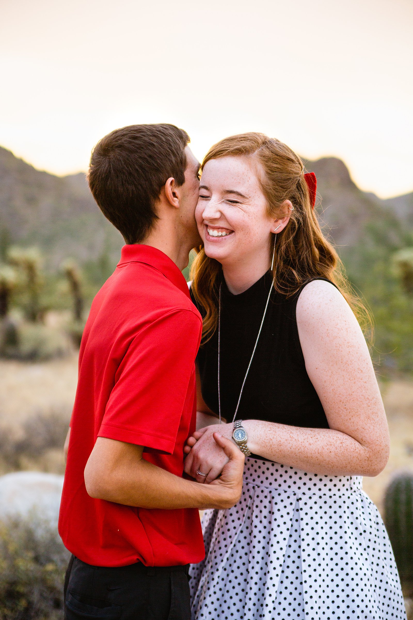 Couple laugh together during their Phoenix anniversary session by Arizona engagement photographer PMA Photography.