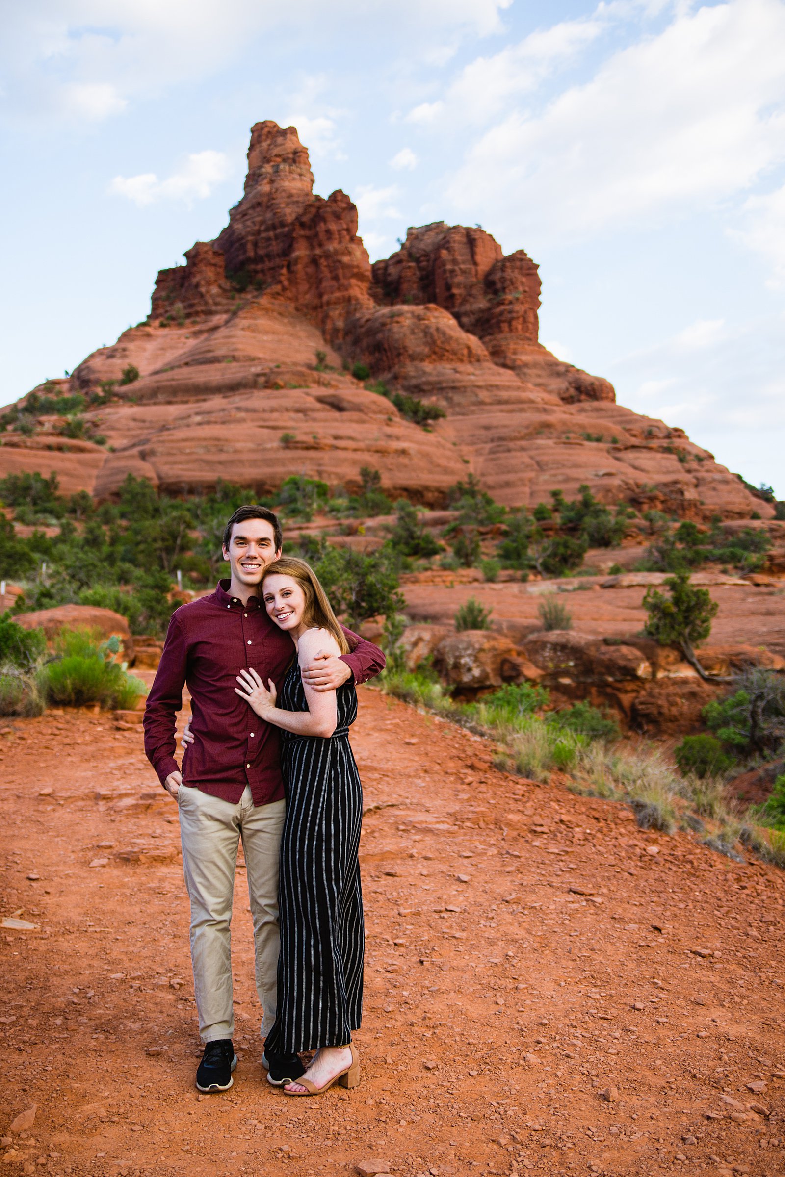 Couple pose for their Bell Rock engagement session by Sedona wedding photographer PMA Photography.