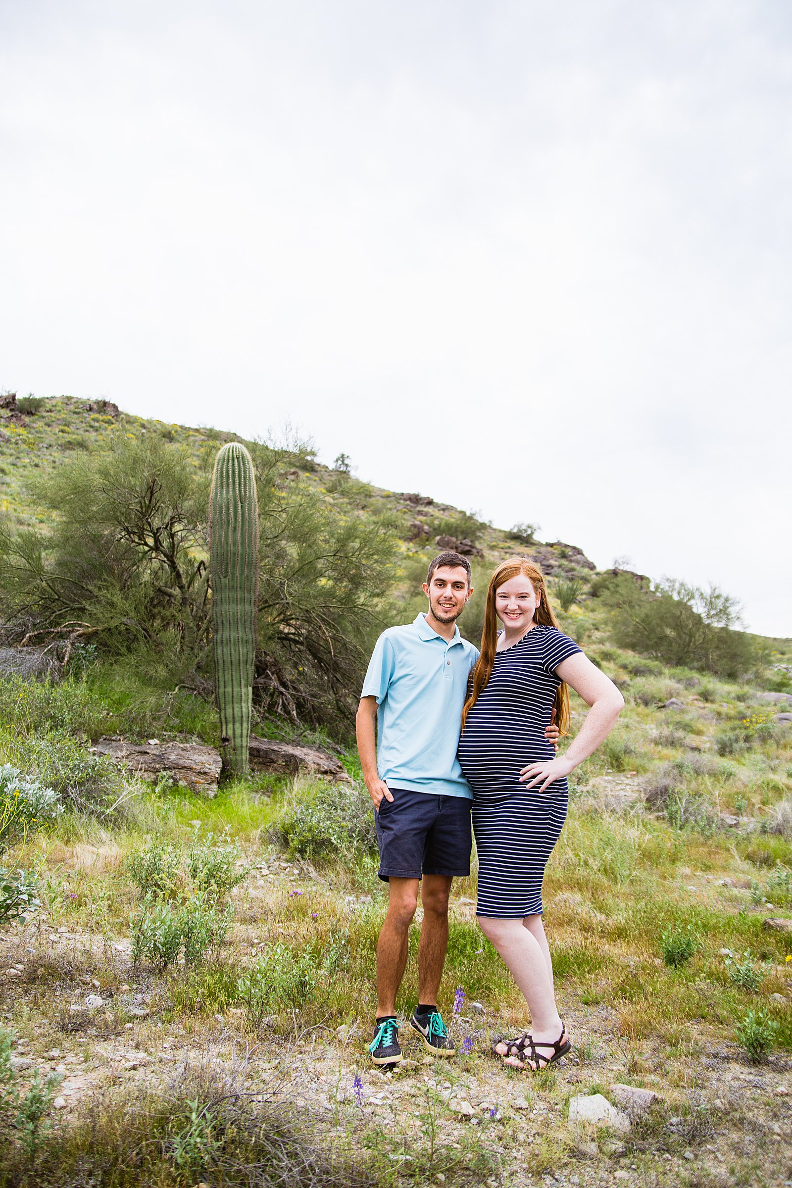 Couple pose for their Pima Canyon maternity session by Phoenix wedding photographer PMA Photography.