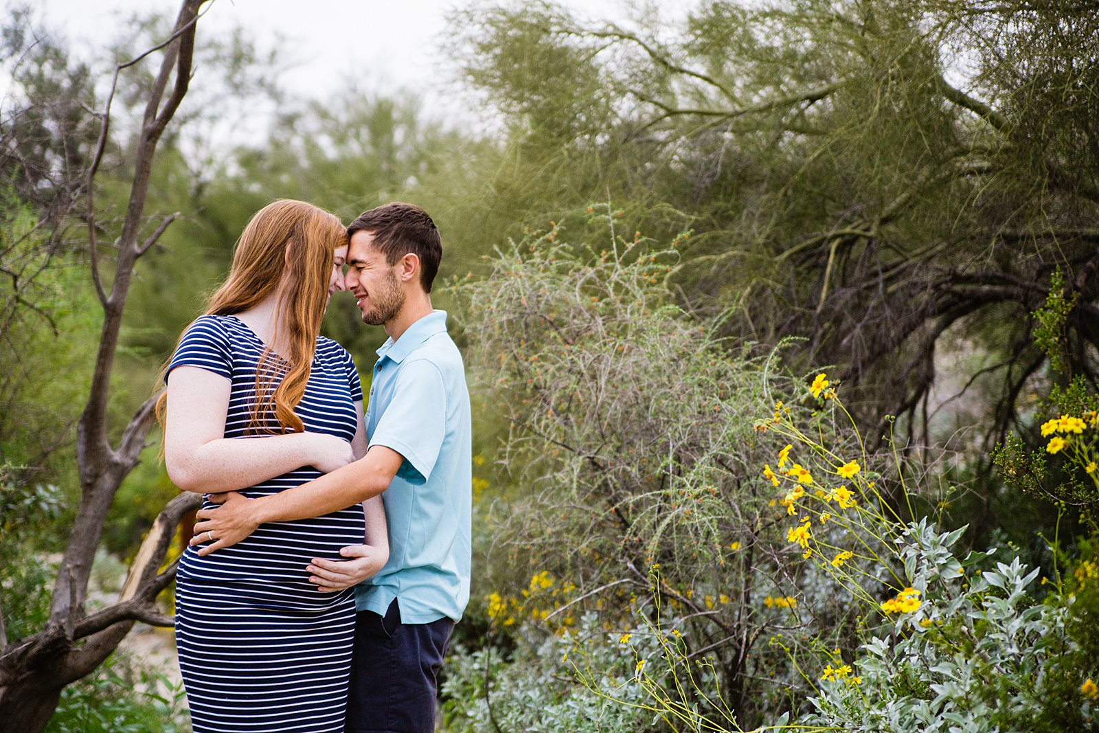 Couple share an intimate moment during their Pima Canyon maternity session by Phoenix engagement photographer PMA Photography.