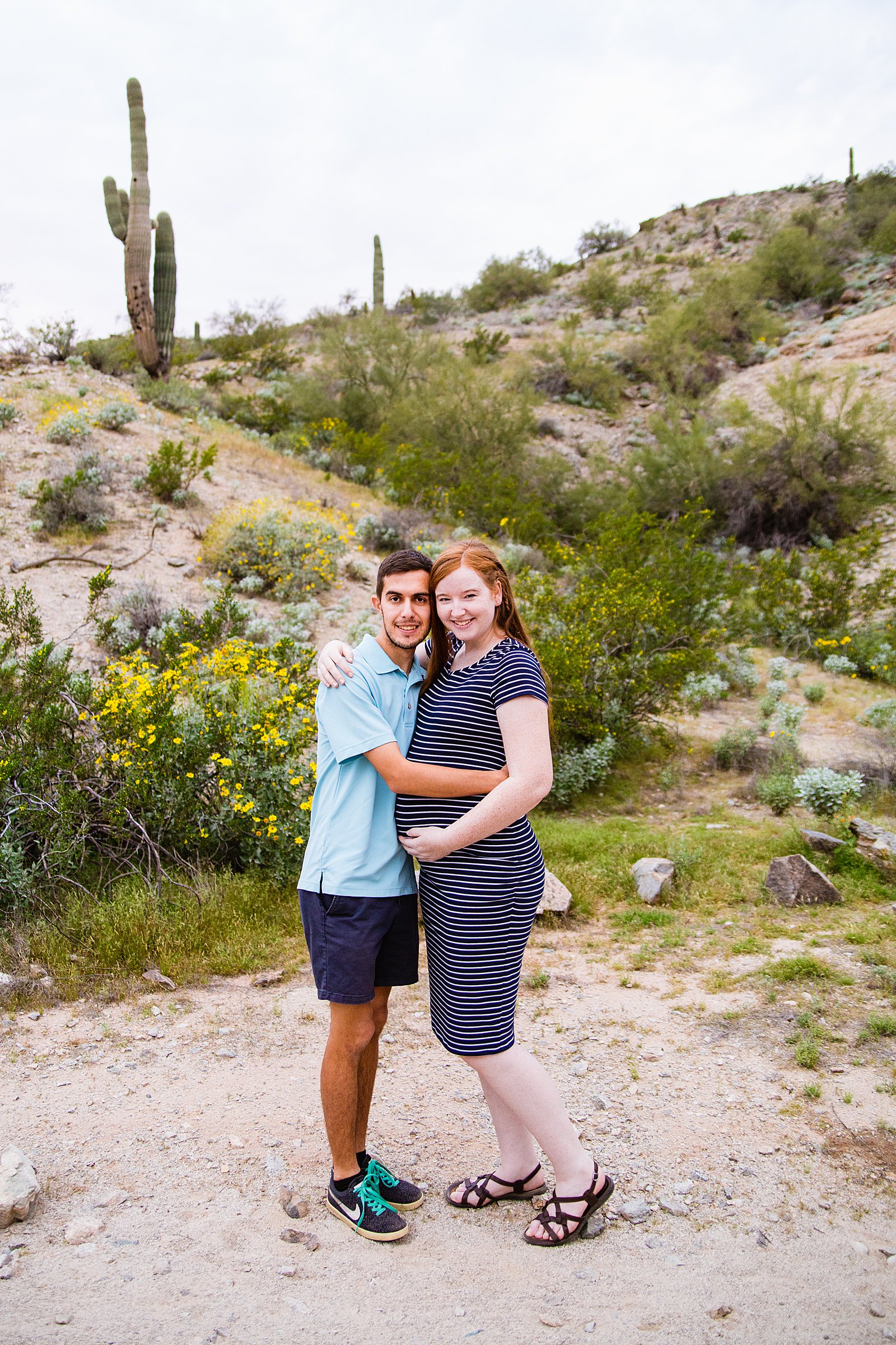Couple pose during their Phoenix maternity session by Arizona wedding photographer PMA Photography.