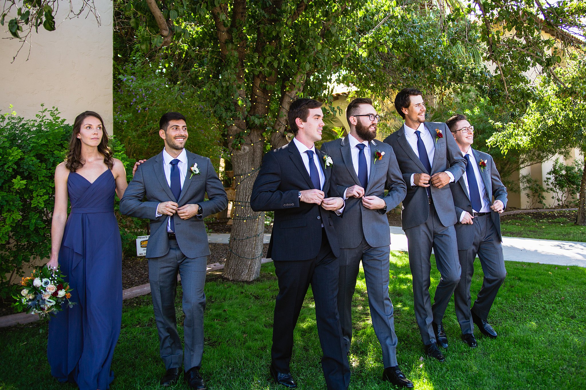 Groom and mixed gender bridal party together at a Secret Garden Events wedding by Arizona wedding photographer PMA Photography.
