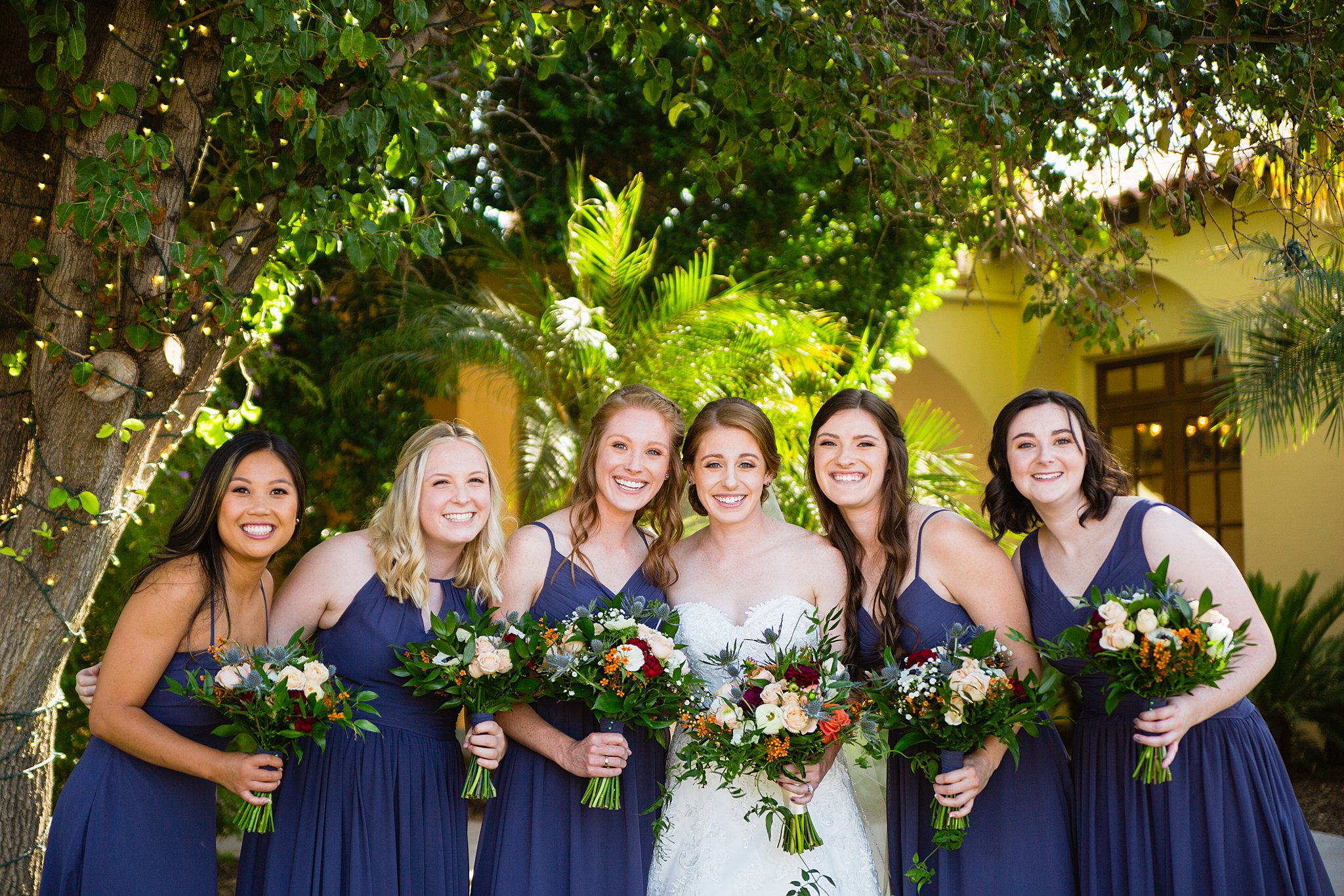 Bride and bridesmaids together at a Secret Garden Events wedding by Arizona wedding photographer PMA Photography.