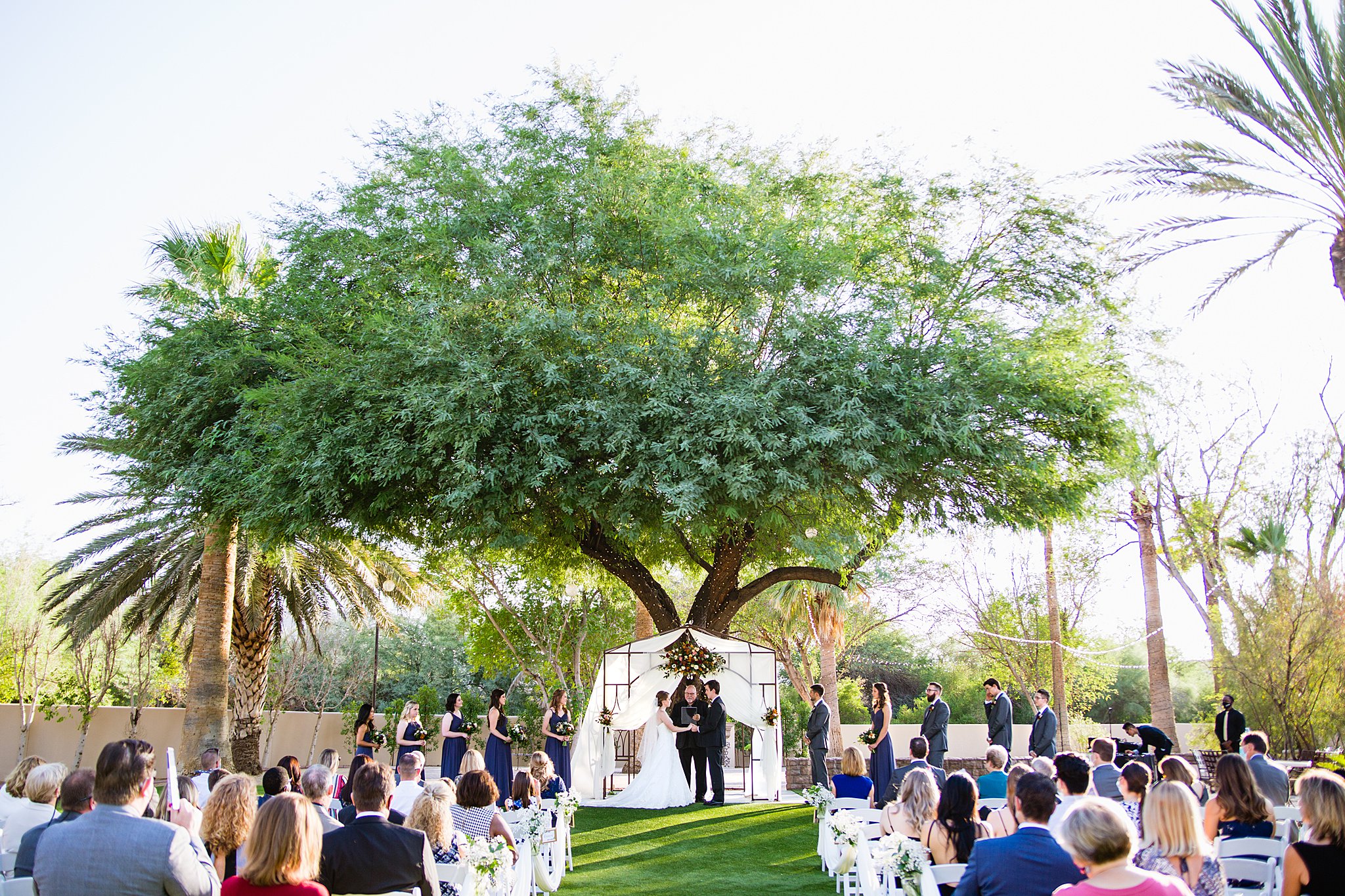 Wedding ceremony at Secret Garden Events by Arizona wedding photographer PMA Photography.