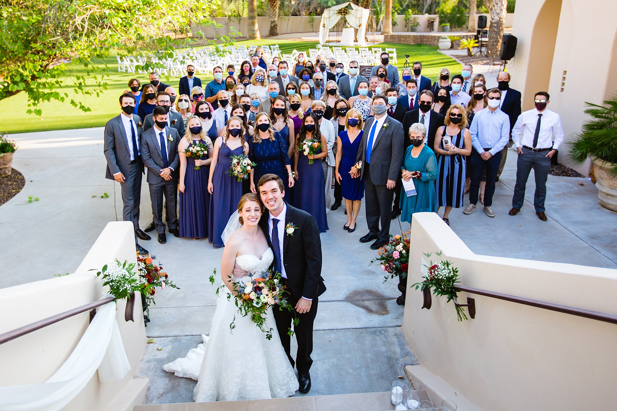 Bride and groom with their wedding guests at a Secret Garden Events Center wedding by Phoenix wedding photographer PMA Photography.