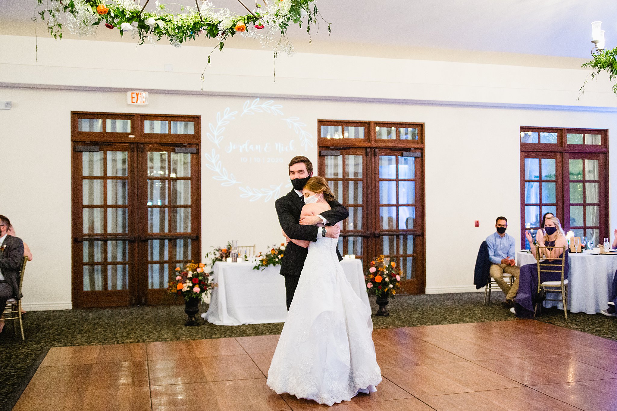 Bride and Groom sharing first dance at their Secret Garden Events wedding reception by Arizona wedding photographer PMA Photography.