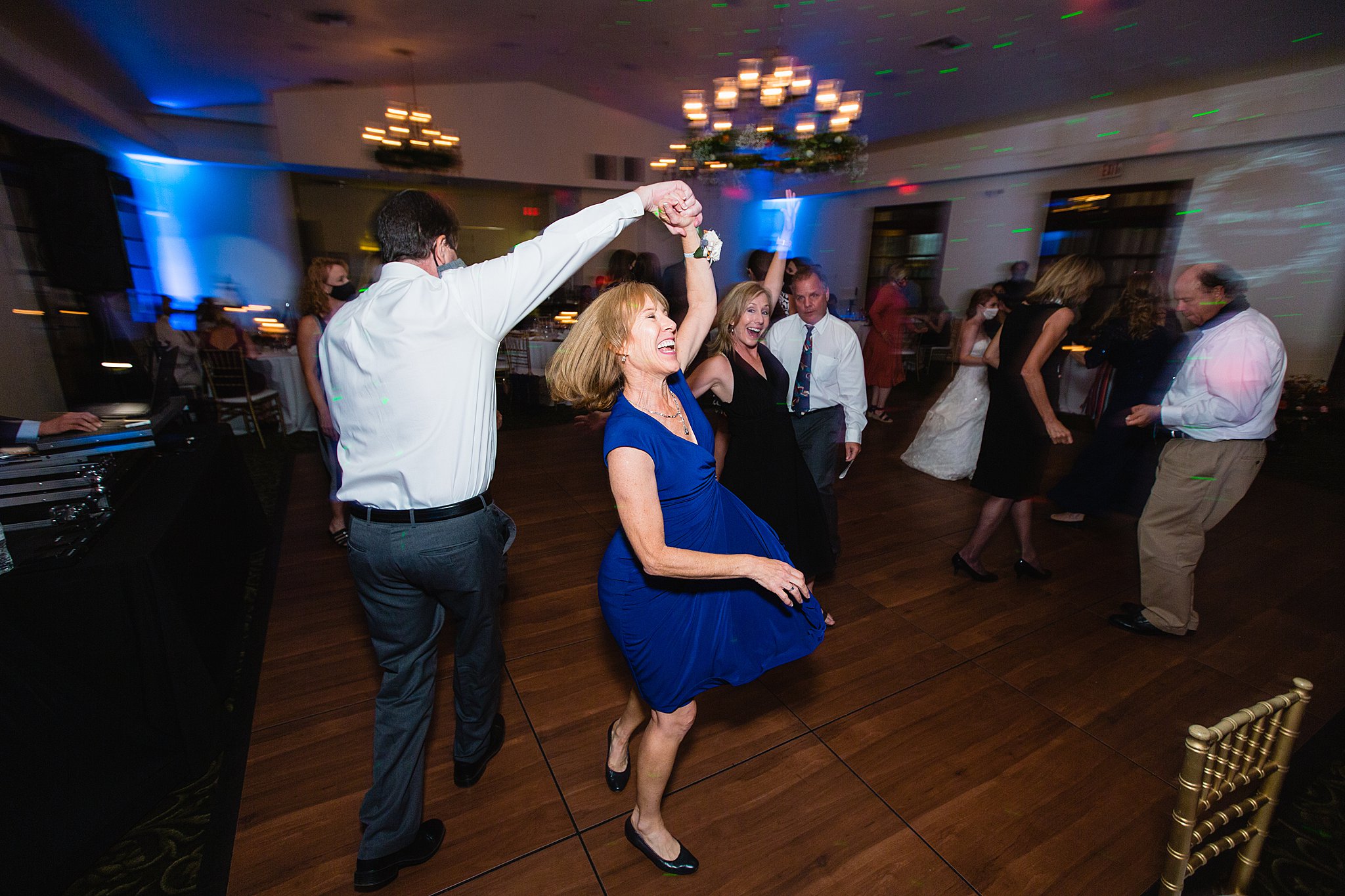 Guests dancing together at Secret Garden Events wedding reception by Phoenix wedding photographer PMA Photography