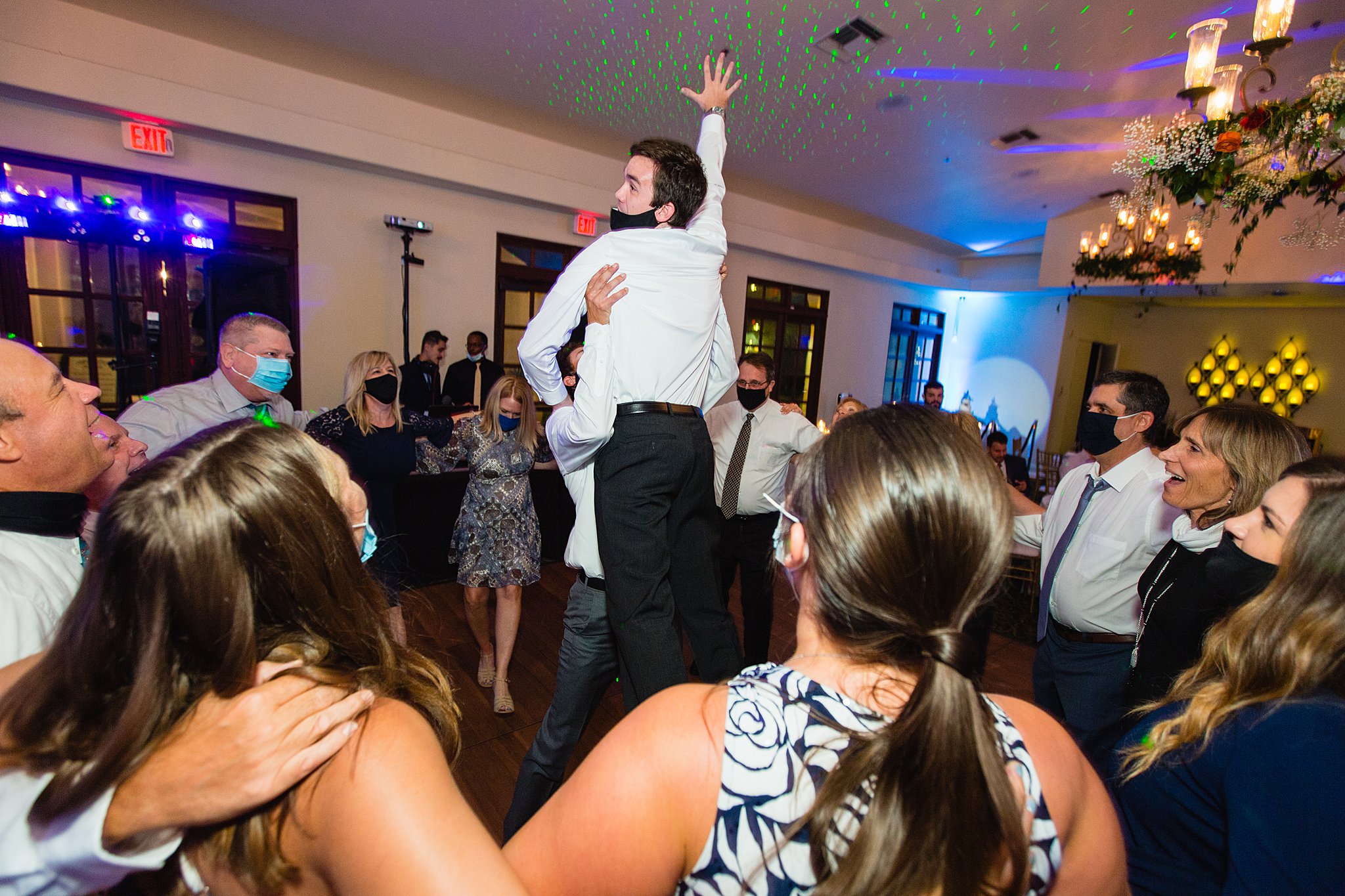 Groom dancing with guests at Secret Garden Events wedding reception by Phoenix wedding photographer PMA Photography