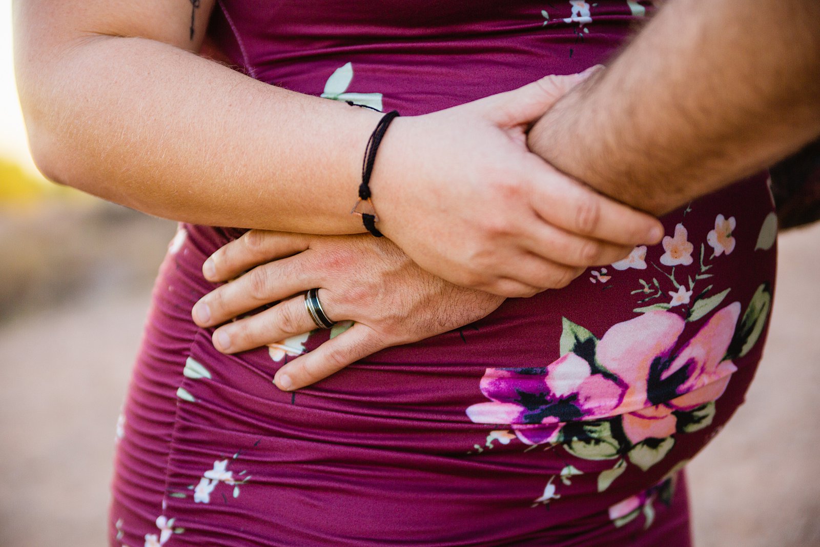 Detail image of couple's maternity session outfits by PMA Photography.