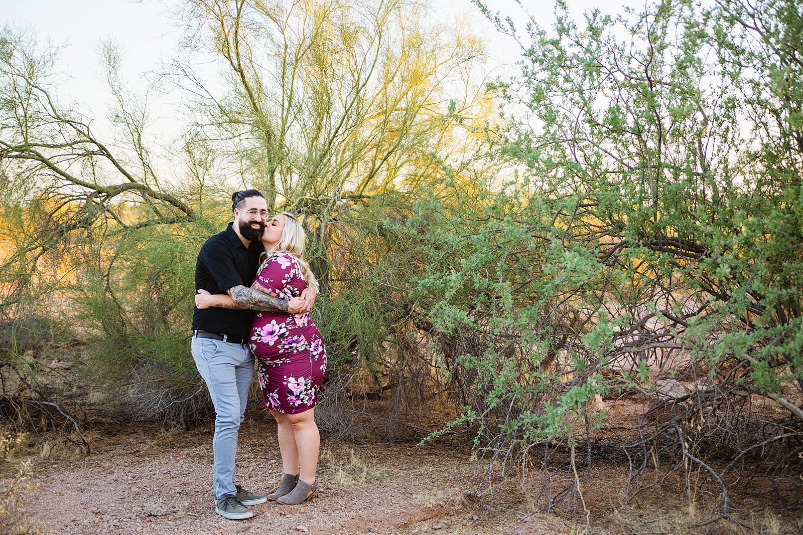 Couple share a kiss during their Papago Park maternity session by Phoenix wedding photographer PMA Photography.