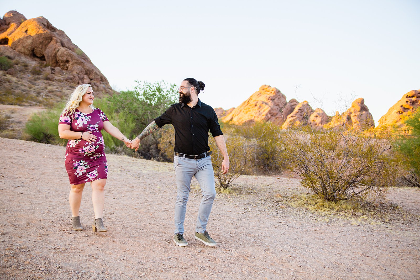 Couple walking together during their Papago Park maternity session by Phoenix engagement photographer PMA Photography.