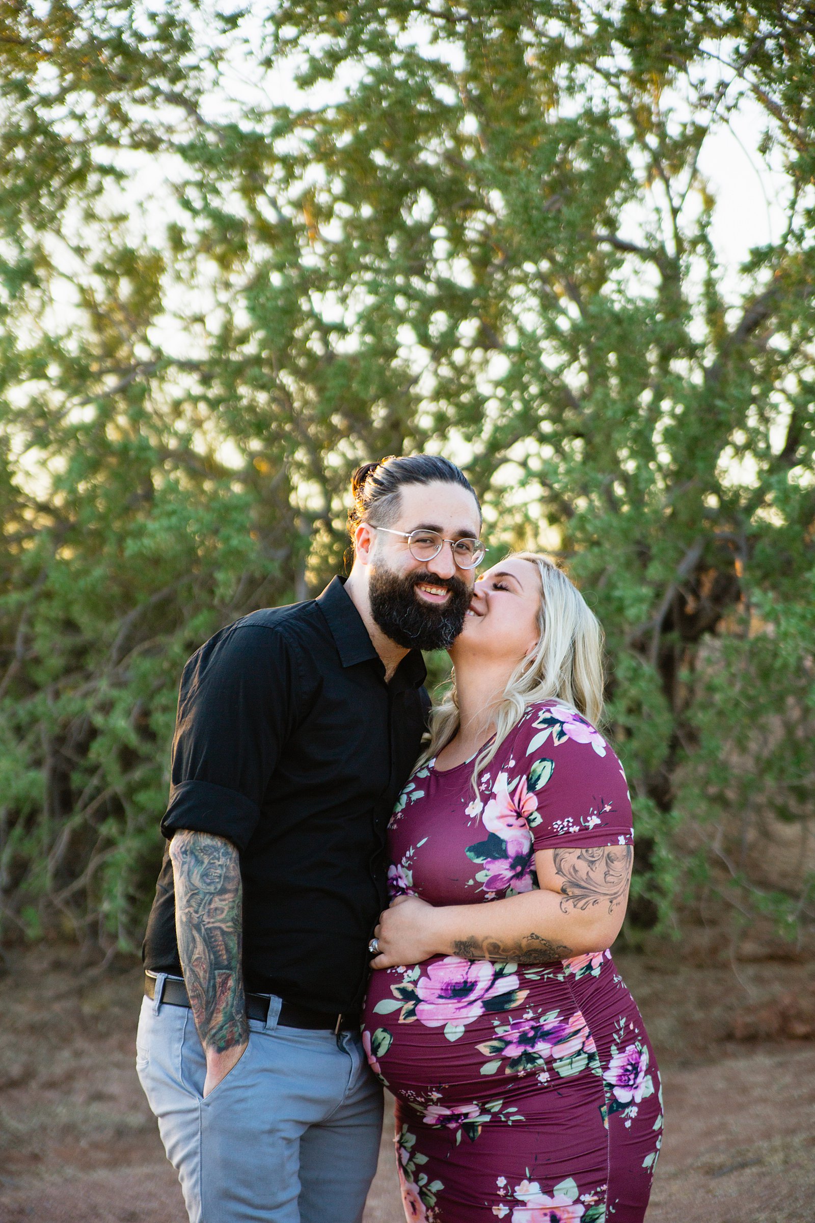 Couple laugh together during their Papago Park maternity session by Phoenix engagement photographer PMA Photography.
