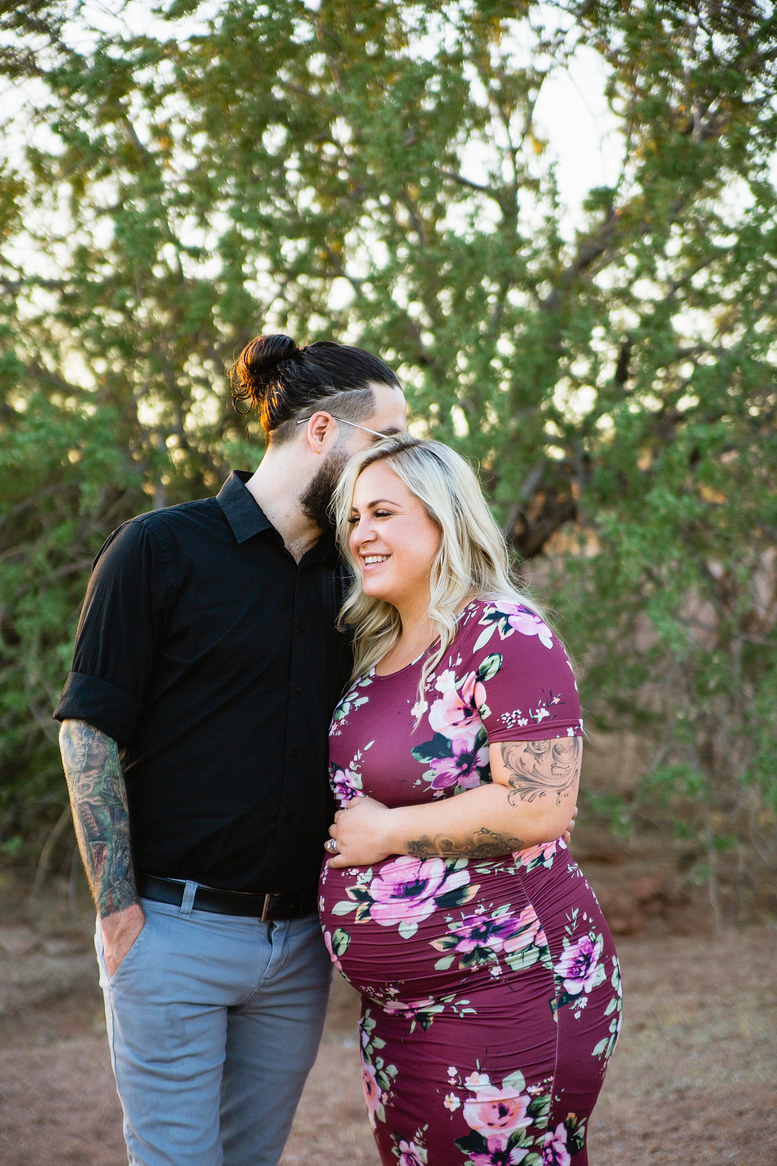 Couple laugh together during their Papago Park maternity session by Phoenix engagement photographer PMA Photography.