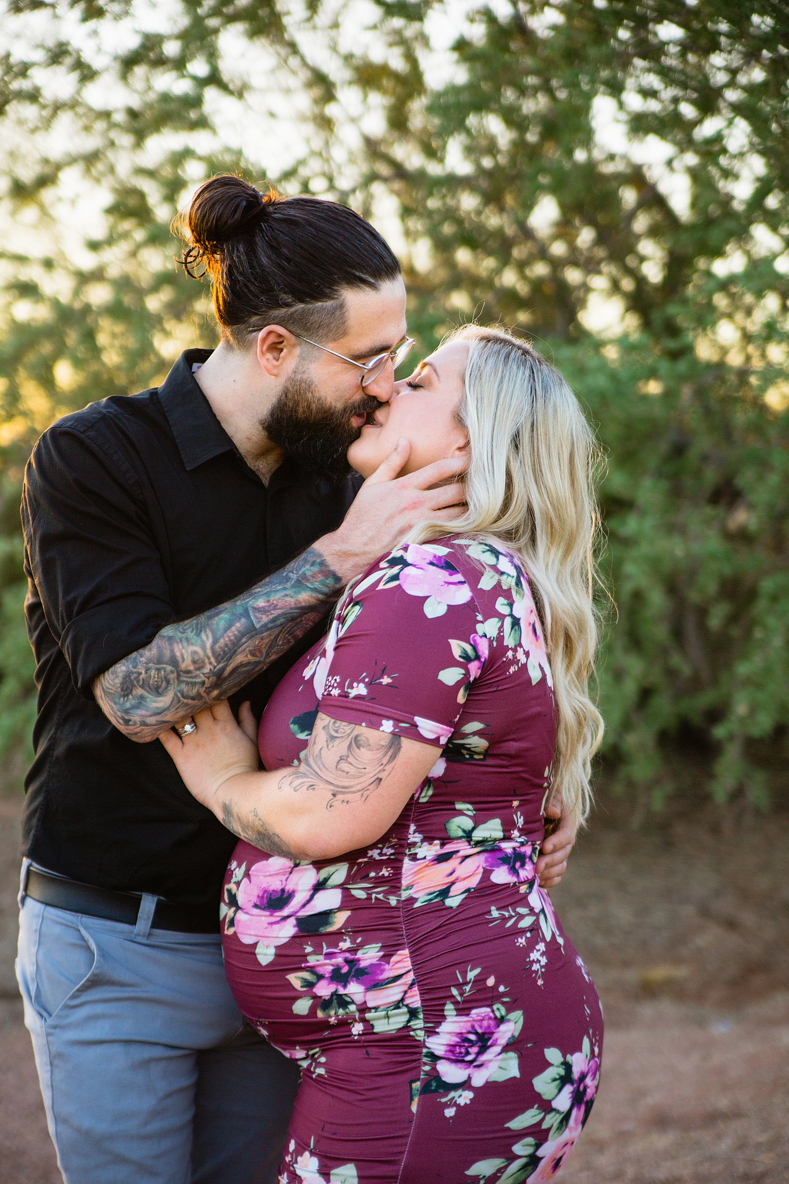Couple share an intimate moment at their Phoenix maternity session by Arizona engagement photographer PMA Photography.