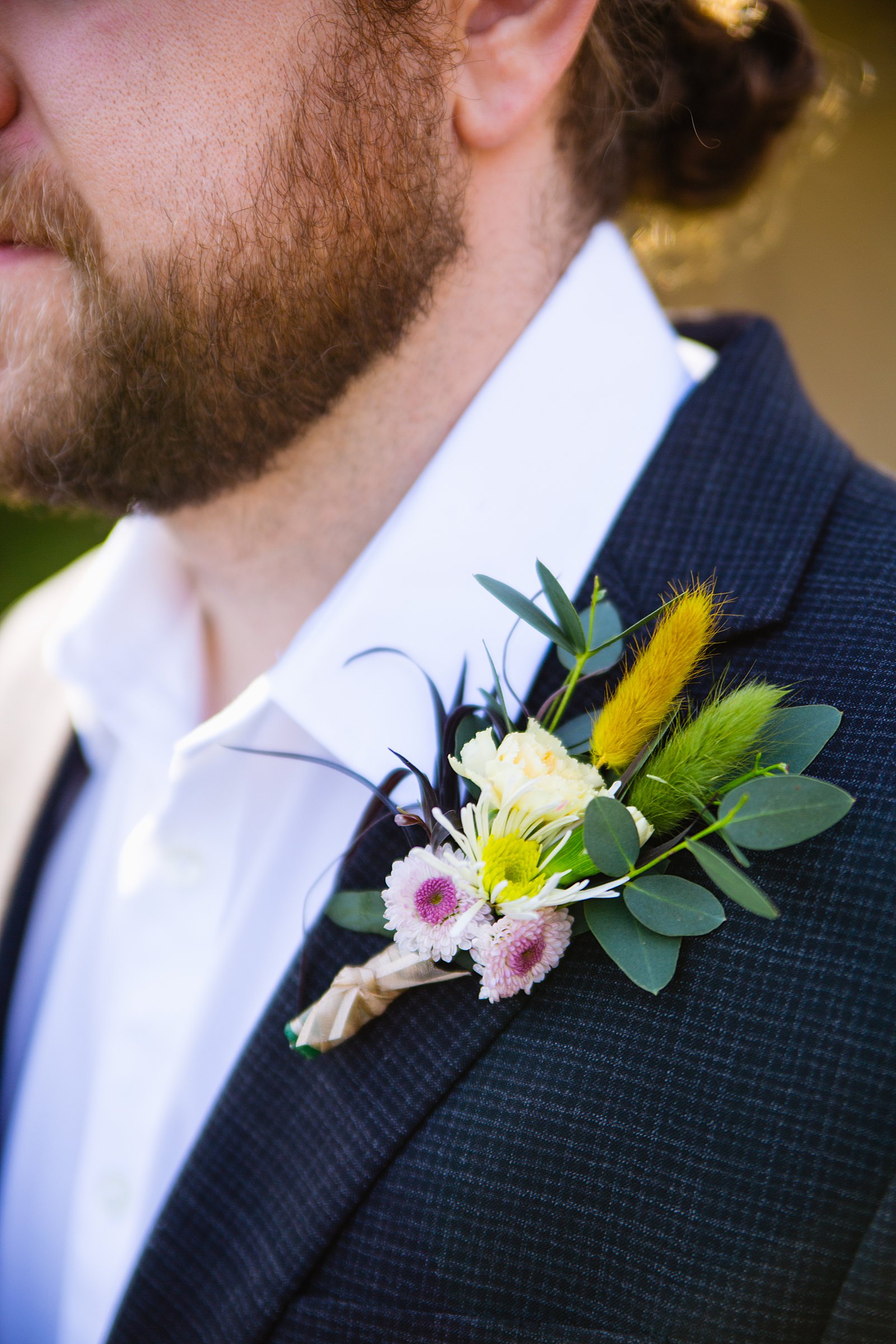 Groom's colorful boho boutonniere by PMA Photography.