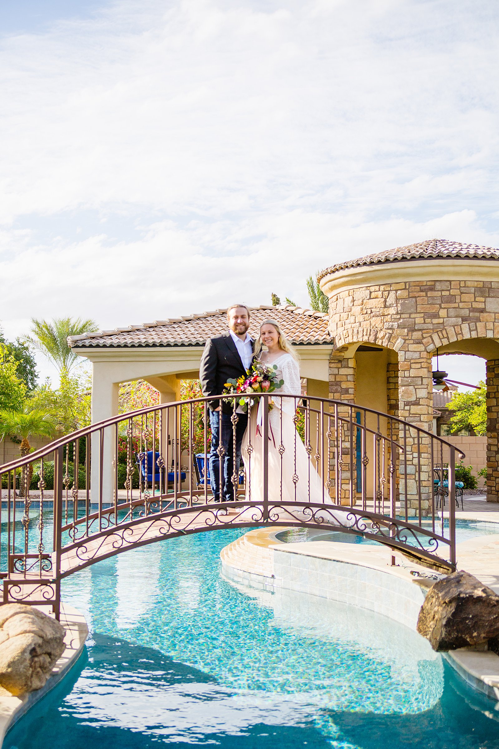 Bride and Groom pose during their backyard wedding by Arizona wedding photographer PMA Photography.