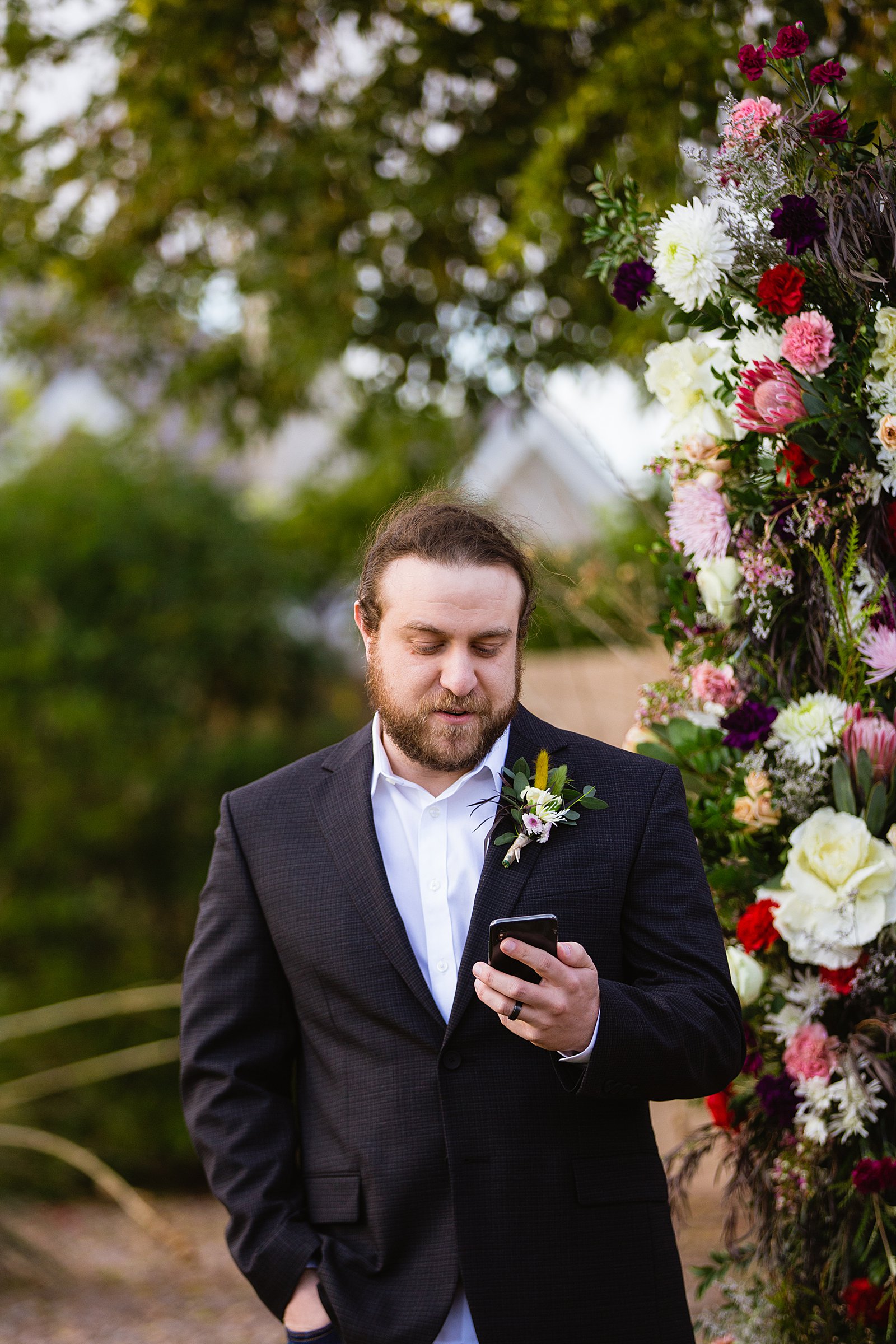 Groom looking at his bride during their wedding ceremony at Backyard by Phoenix wedding photographer PMA Photography.