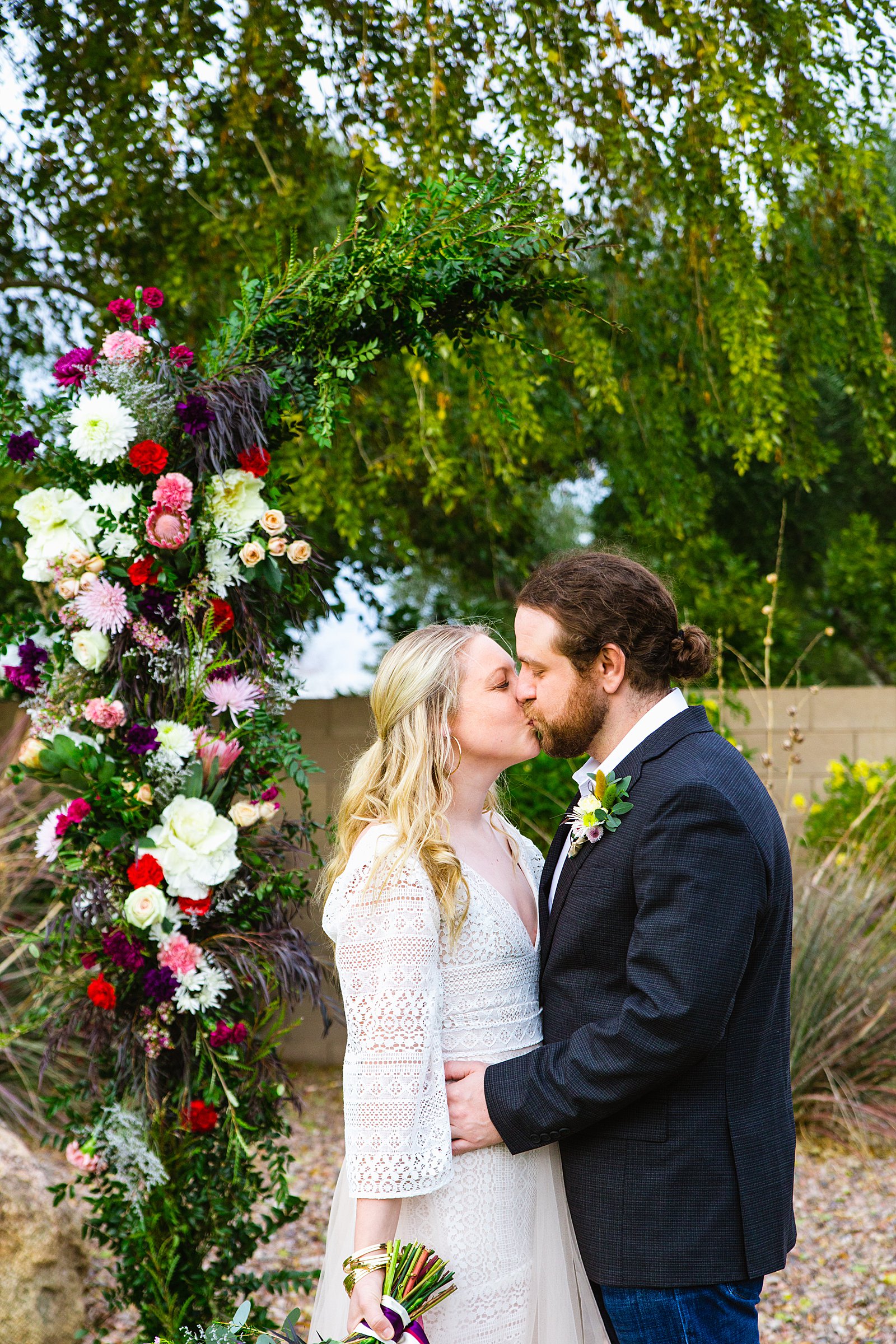 Bride and Groom share a kiss during their Backyard wedding by Arizona wedding photographer PMA Photography.