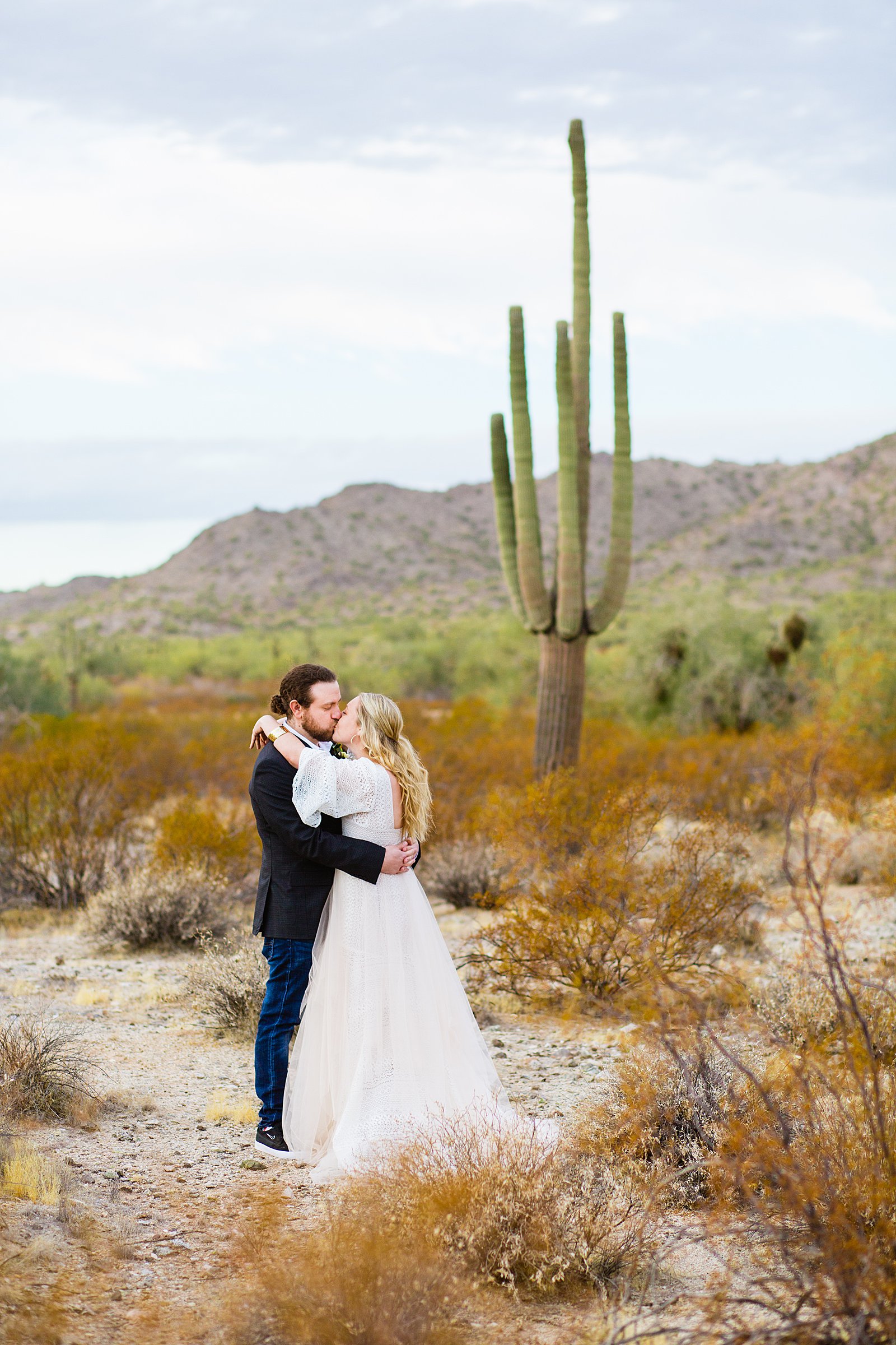Bride and Groom share a kiss during their San Tan Regional Park wedding by Arizona wedding photographer PMA Photography.
