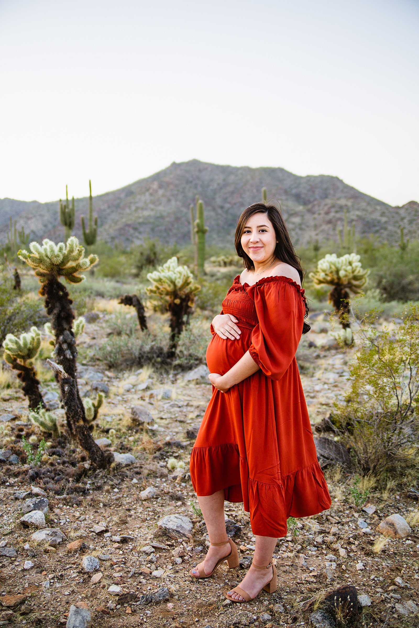 Mom posing with her baby bump for a Phoenix maternity session by Arizona engagement photographer PMA Photography.