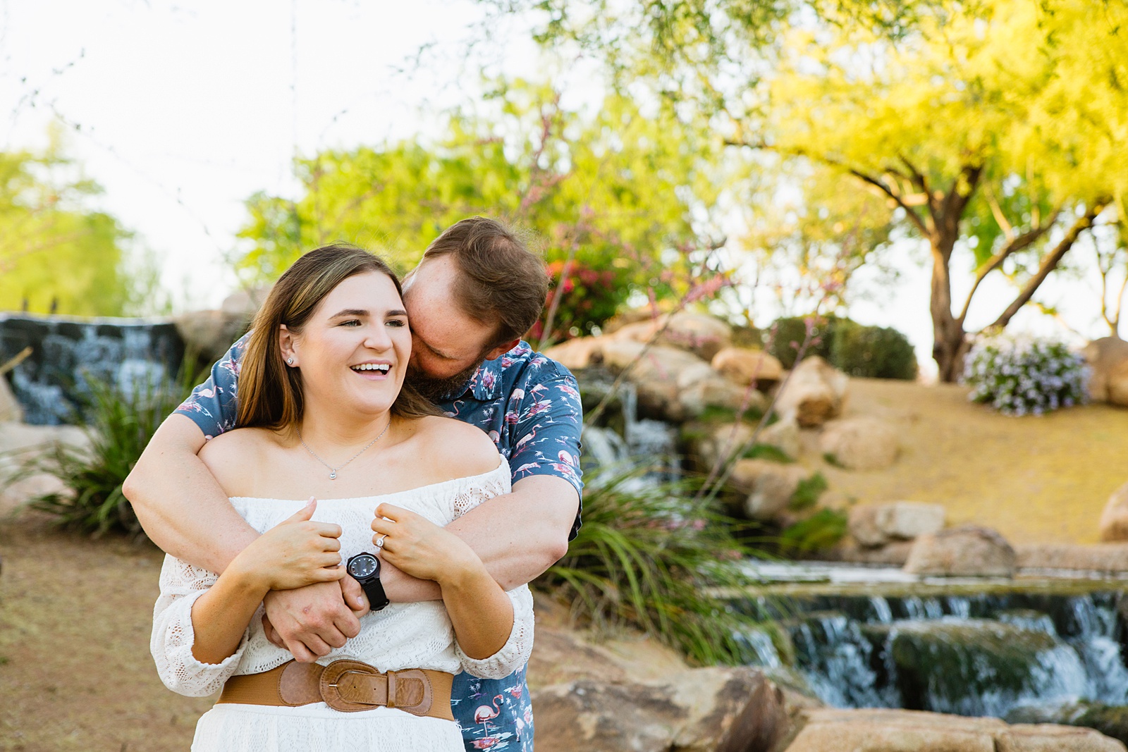 Couple laugh together during their Anthem Park engagement session by Phoenix engagement photographer PMA Photography.