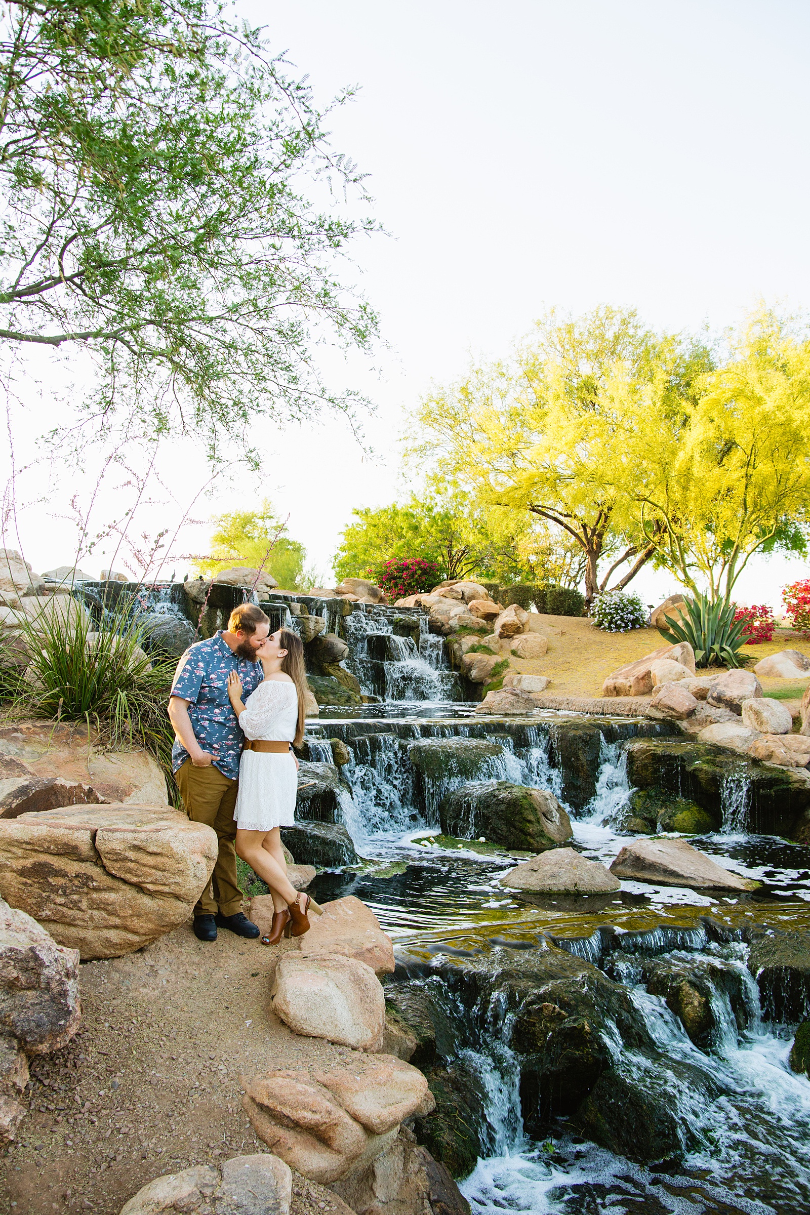 Couple share a kiss during their Anthem Park engagement session by Phoenix wedding photographer PMA Photography.