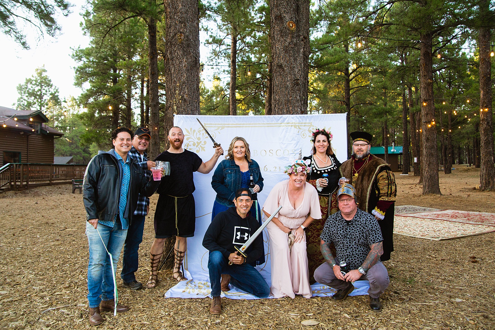 Guests pose at a fairy tale inspired DIY photo booth by Arizona wedding photographer PMA Photography.