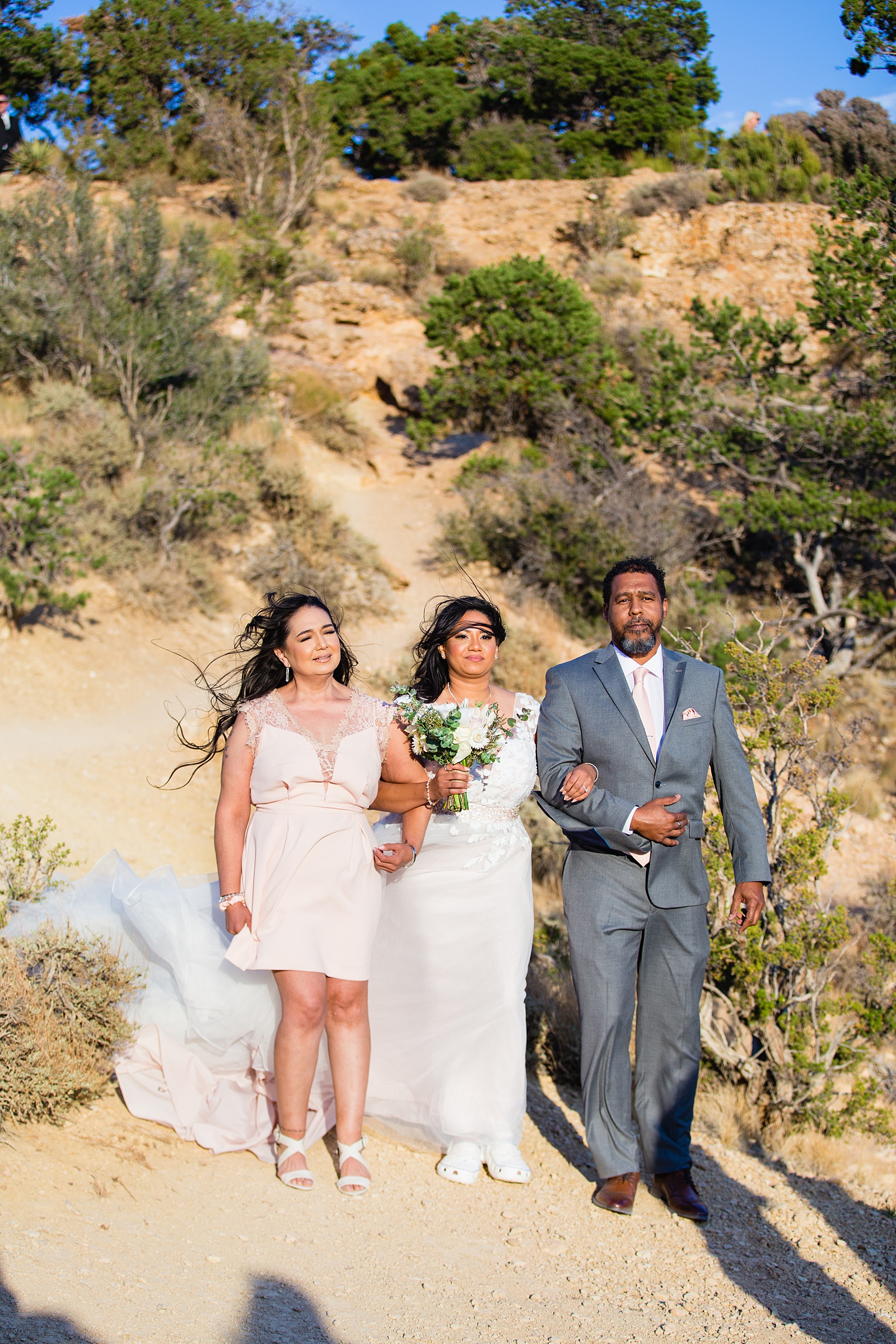 Bride walking down aisle during Moran Point wedding ceremony by Arizona elopement photographer PMA Photography.