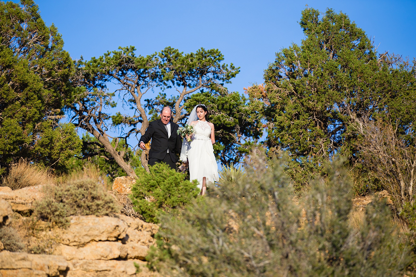 Bride walking down aisle during Moran Point wedding ceremony by Arizona elopement photographer PMA Photography.