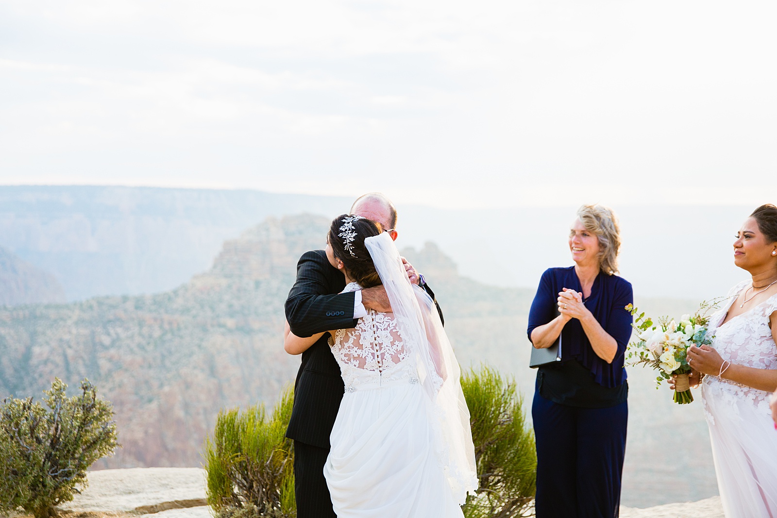 Bride hugging her father at the end of the aisle by Grand Canyon Elopement Photographer PMA Photography.