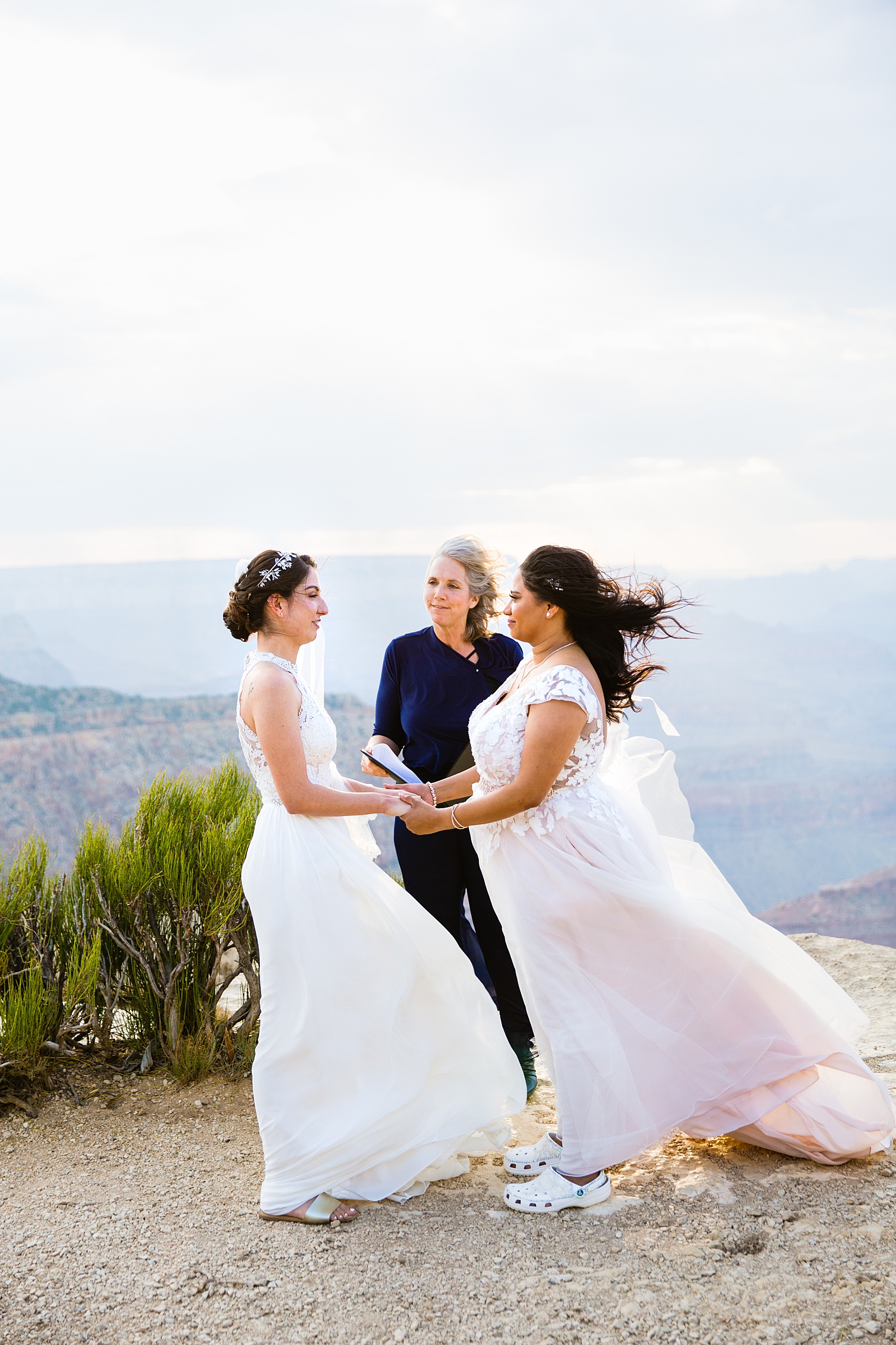 Brides looking at each other during their wedding ceremony at Moran Point by Grand Canyon elopement photographer PMA Photography.