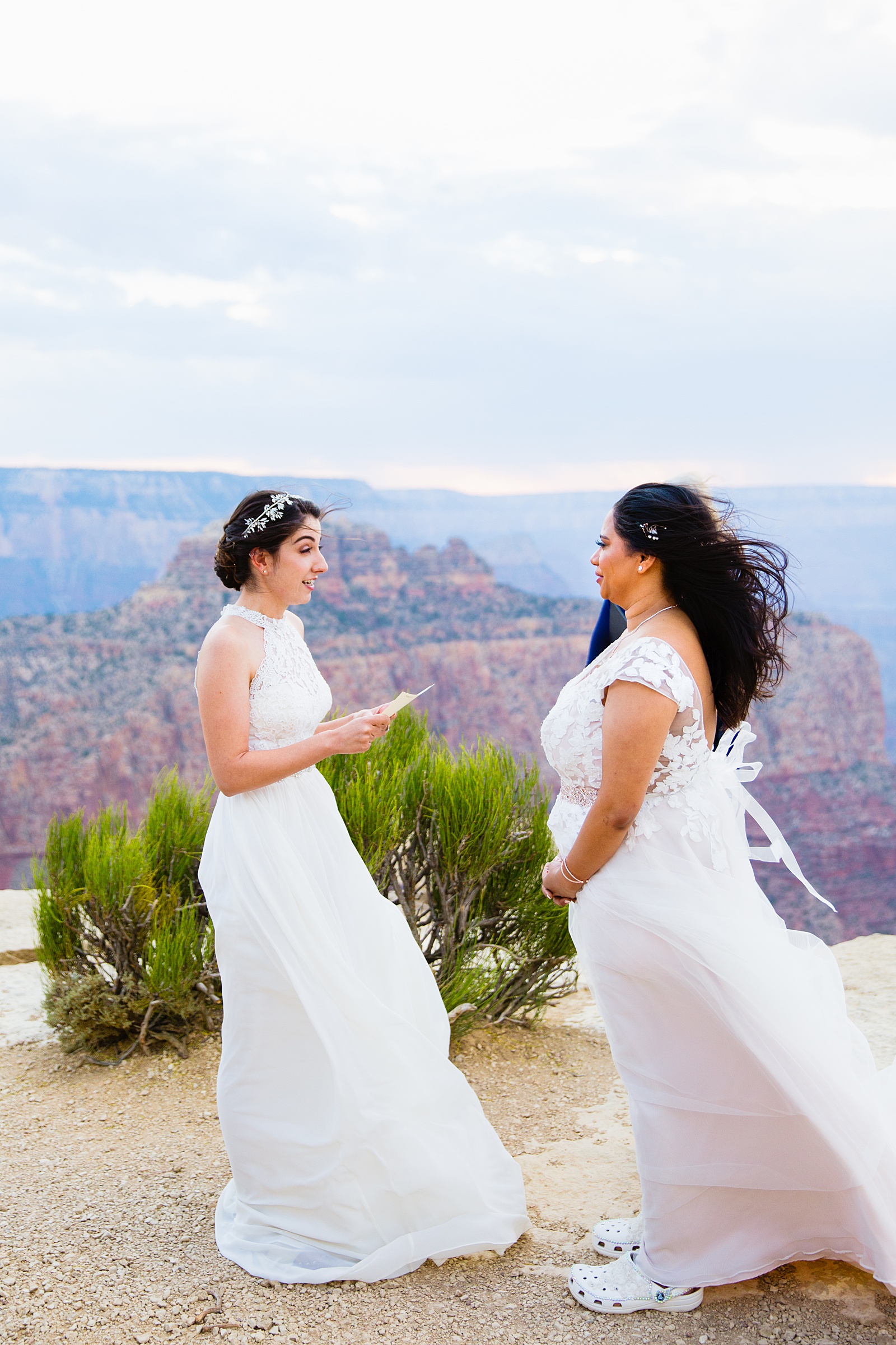 Same sex couple exchange vows during their wedding ceremony at Moran Point by Arizona elopement photographer PMA Photography.
