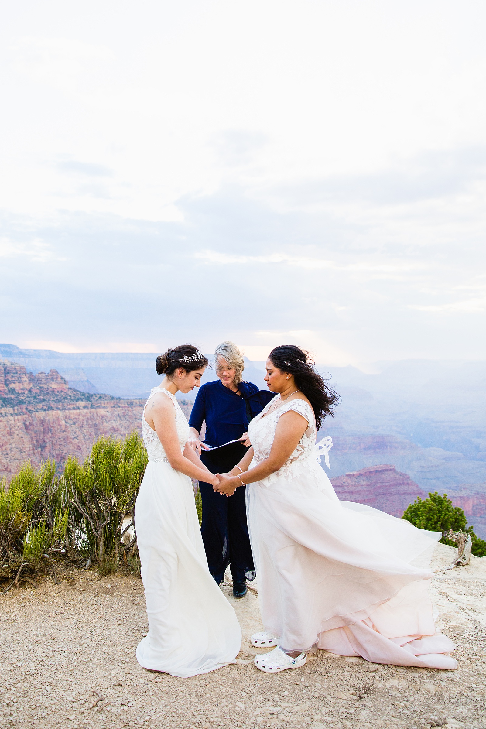 Same sex couple togethering during Moran Point wedding ceremony by Grand Canyon elopement photographer PMA Photography.