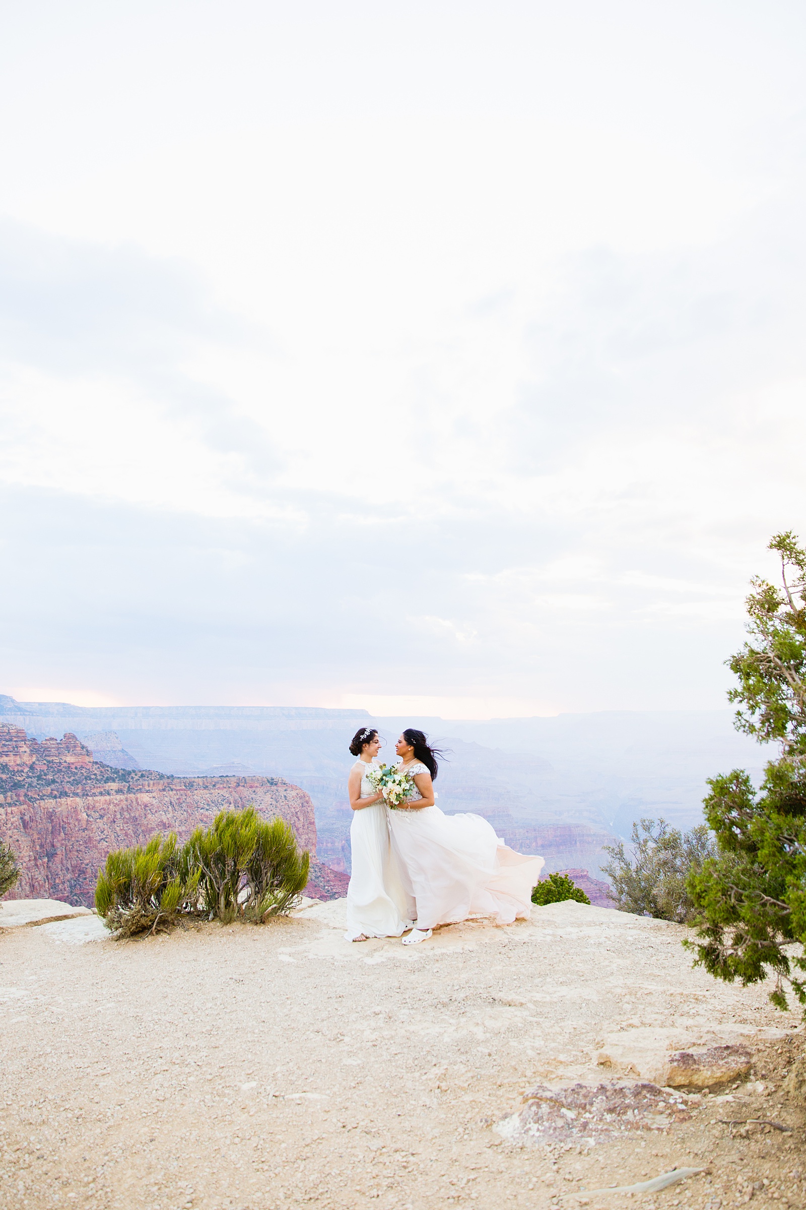 Adventurous LGBTQ+ couple pose for their Moran Point elopement by Grand Canyon elopement photographer PMA Photography.