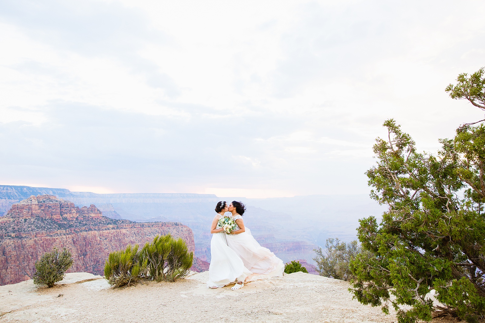 Adventurous LGBTQ+ couple share a kiss during their Moran Point elopement by Arizona elopement photographer PMA Photography.