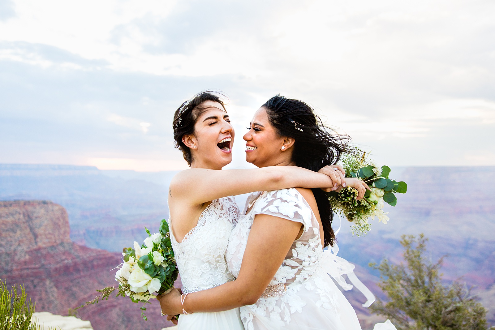 Adventurous LGBTQ+ couple laughing together during their Moran Point elopement by Grand Canyon elopement photographer PMA Photography.
