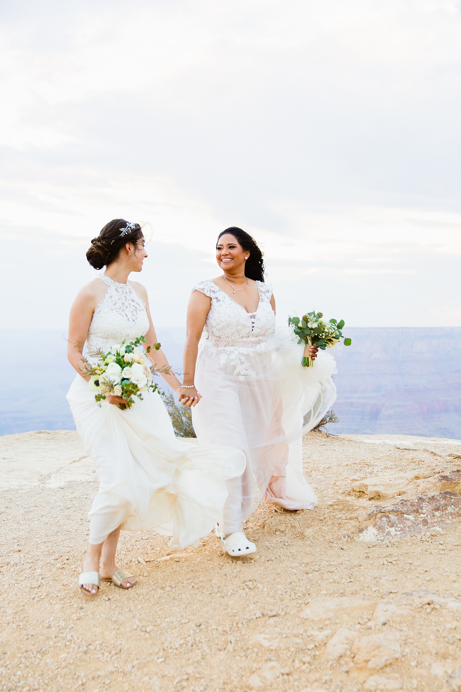 Adventurous LGBTQ+ couple walking together during their Moran Point elopement by Grand Canyon elopement photographer PMA Photography.