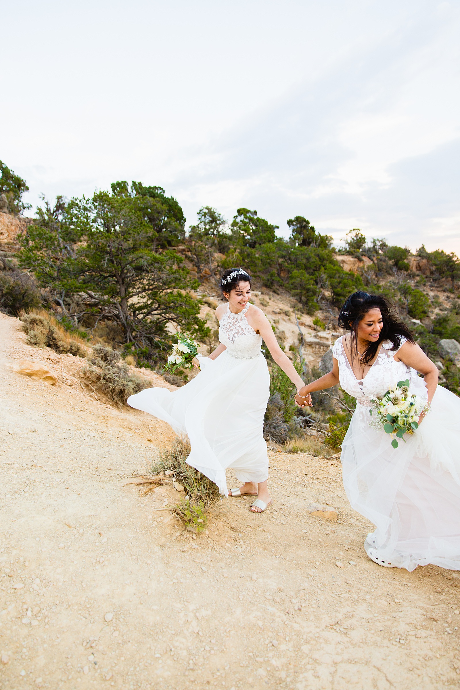 Adventurous LGBTQ+ couple walking together during their Moran Point elopement by Arizona elopement photographer PMA Photography.