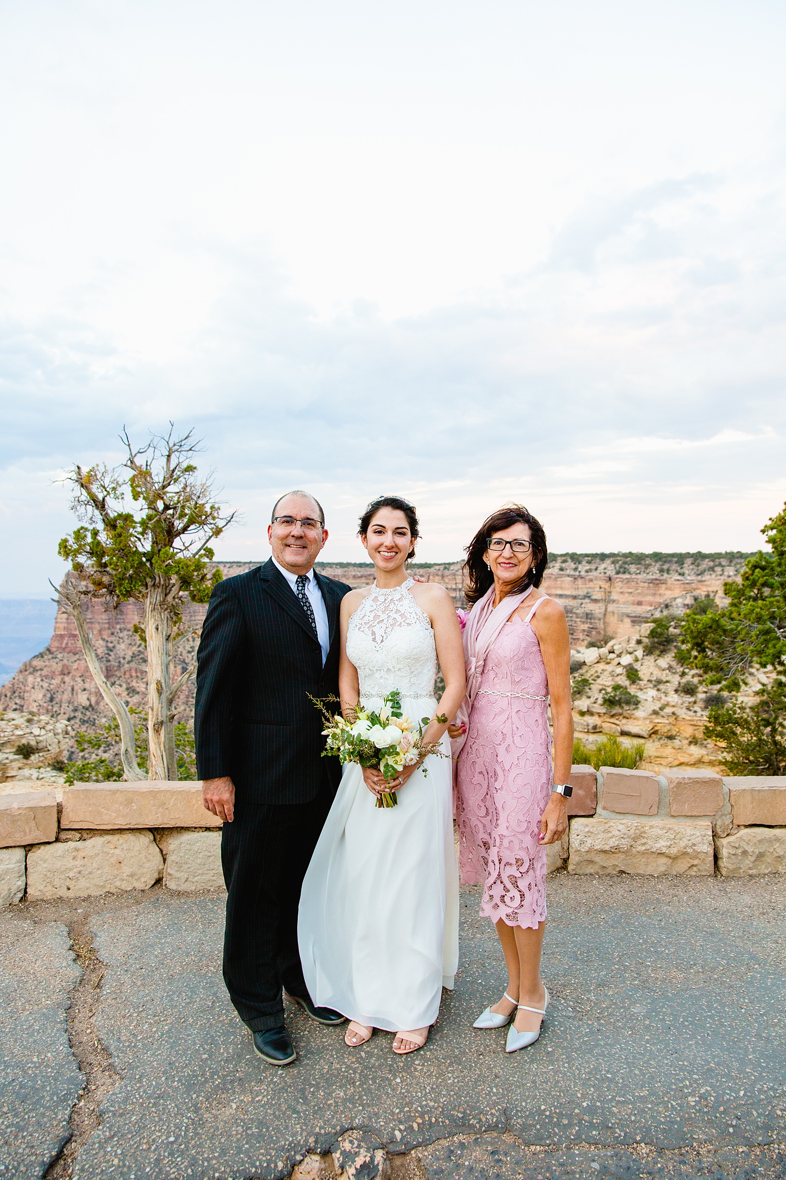 Bride poses with her family at her Grand Canyon Elopement by Arizona elopement photographer PMA Photography.