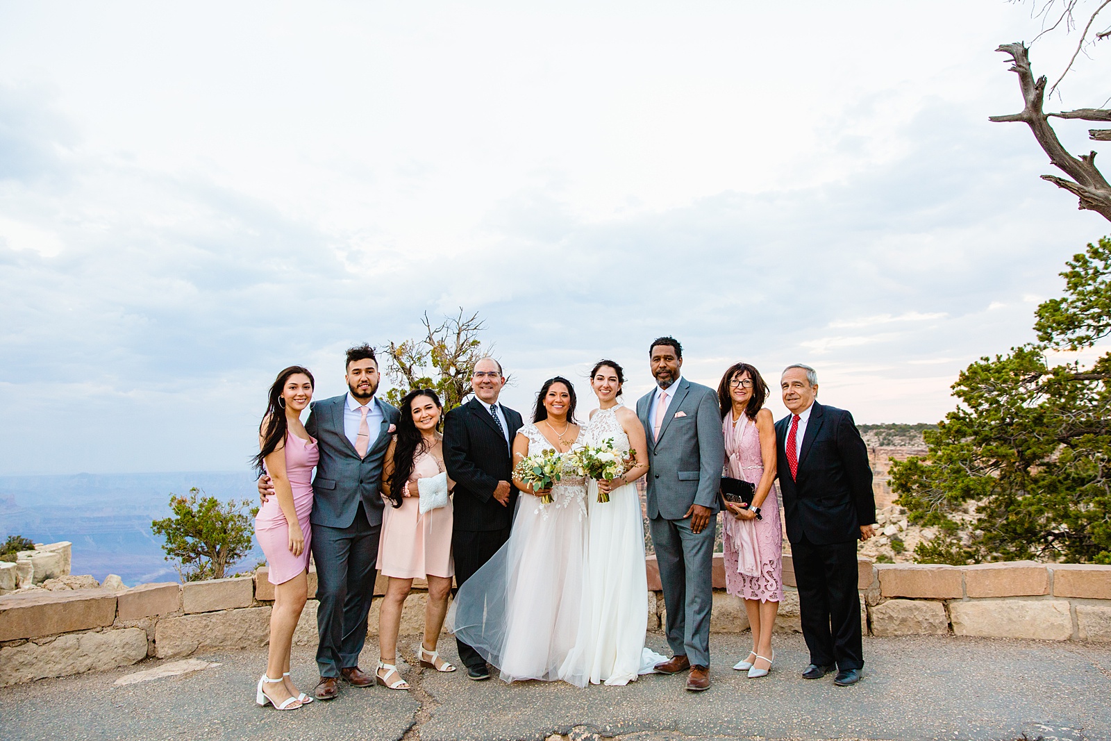 Brides poses with their family at her Grand Canyon Elopement by Arizona elopement photographer PMA Photography.