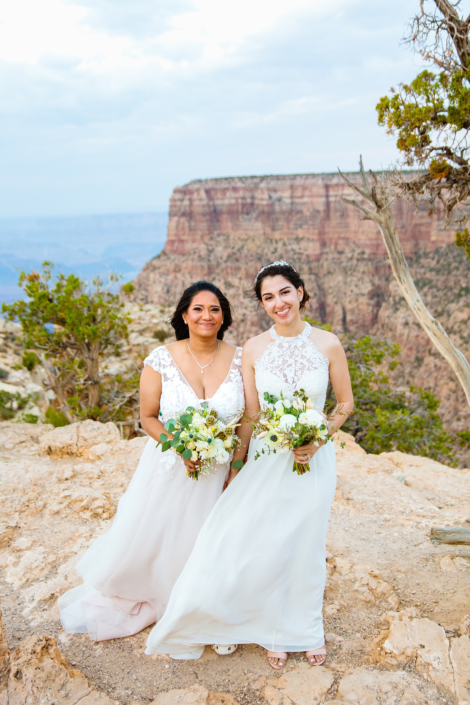 Adventurous lesbian couple pose during their Moran Point elopement by Arizona elopement photographer PMA Photography.
