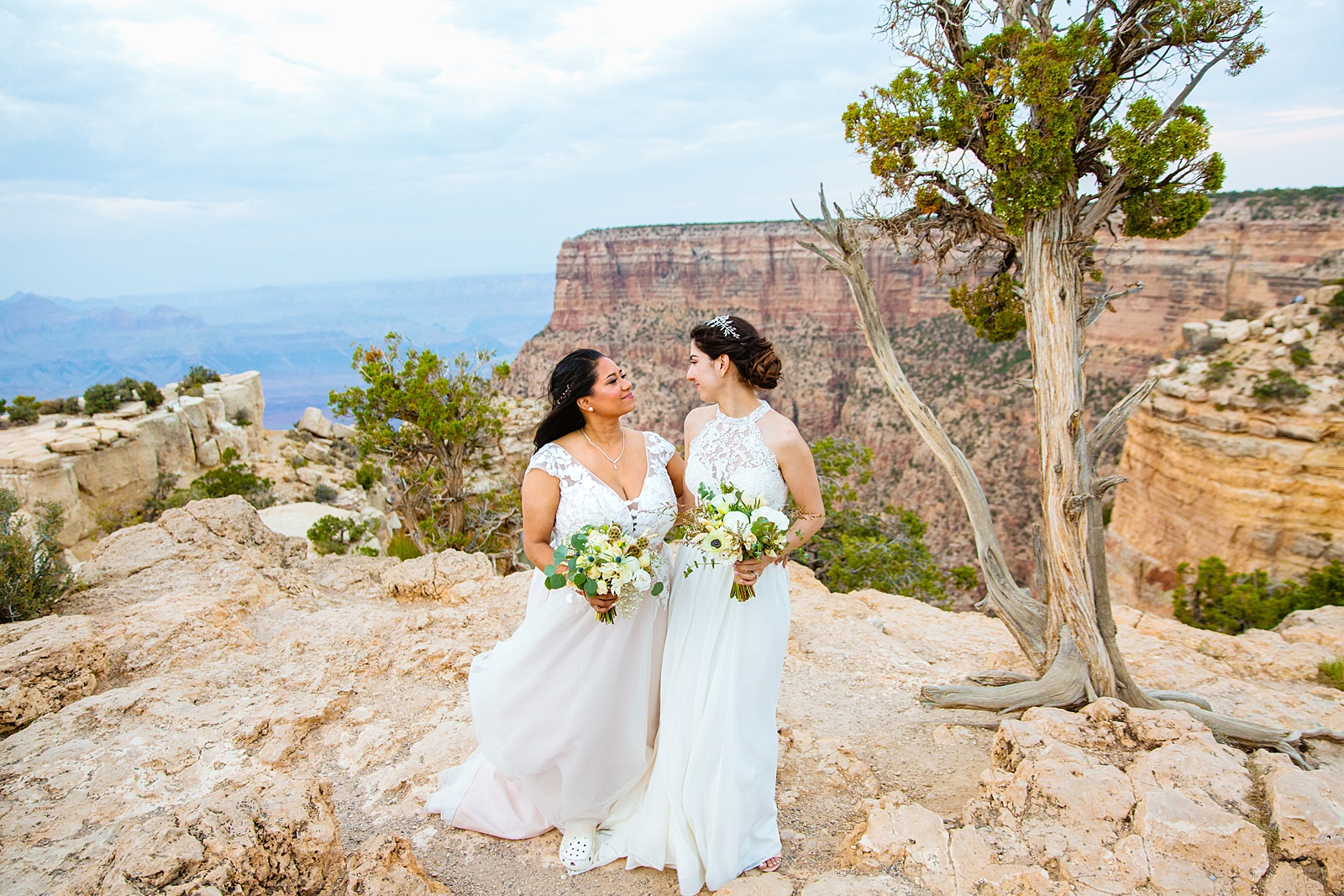 Adventurous lesbian couple pose for their Moran Point elopement by Grand Canyon elopement photographer PMA Photography.