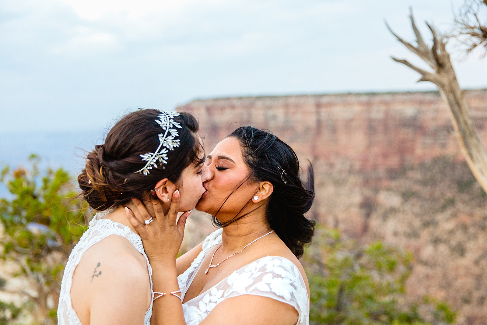 Same sex couple share a kiss during their Moran Point elopement by Grand Canyon elopement photographer PMA Photography.