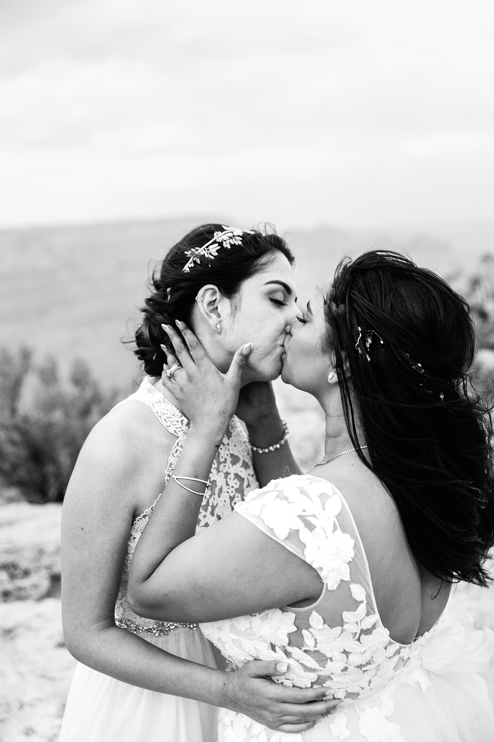 Same sex couple share a kiss during their Moran Point elopement by Arizona elopement photographer PMA Photography.