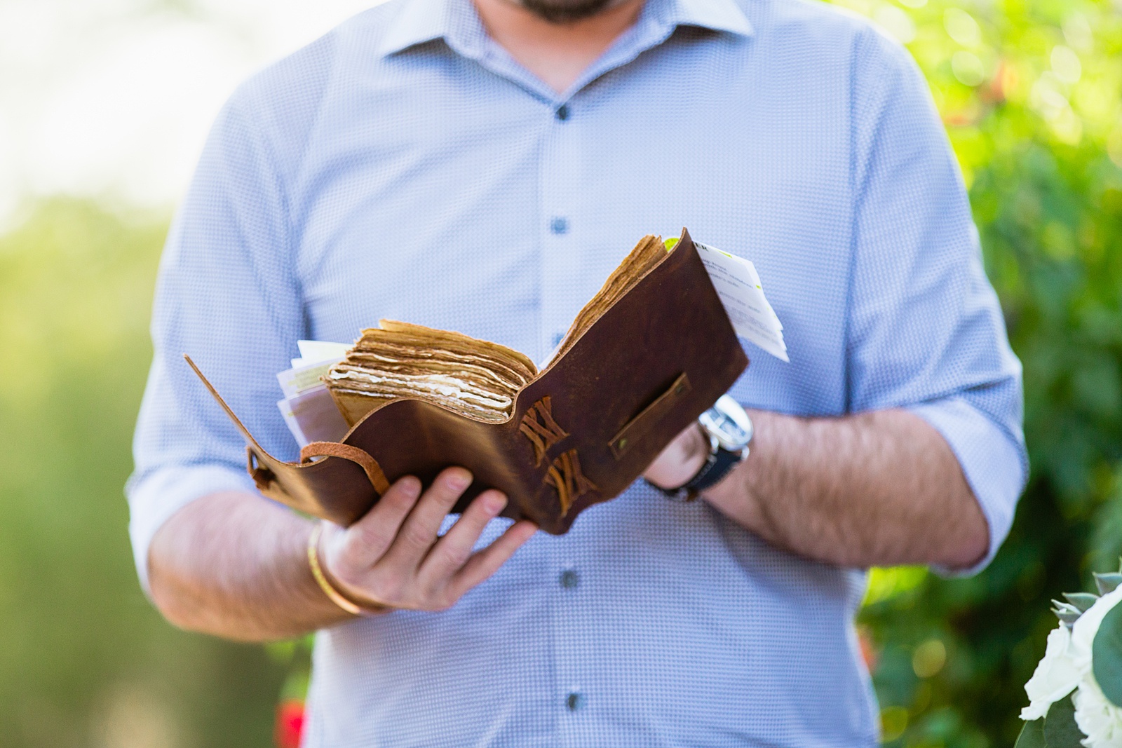 Close up image of the leather bound book the officiant is reading the wedding ceremony from by Arizona elopement photographer PMA Photography.